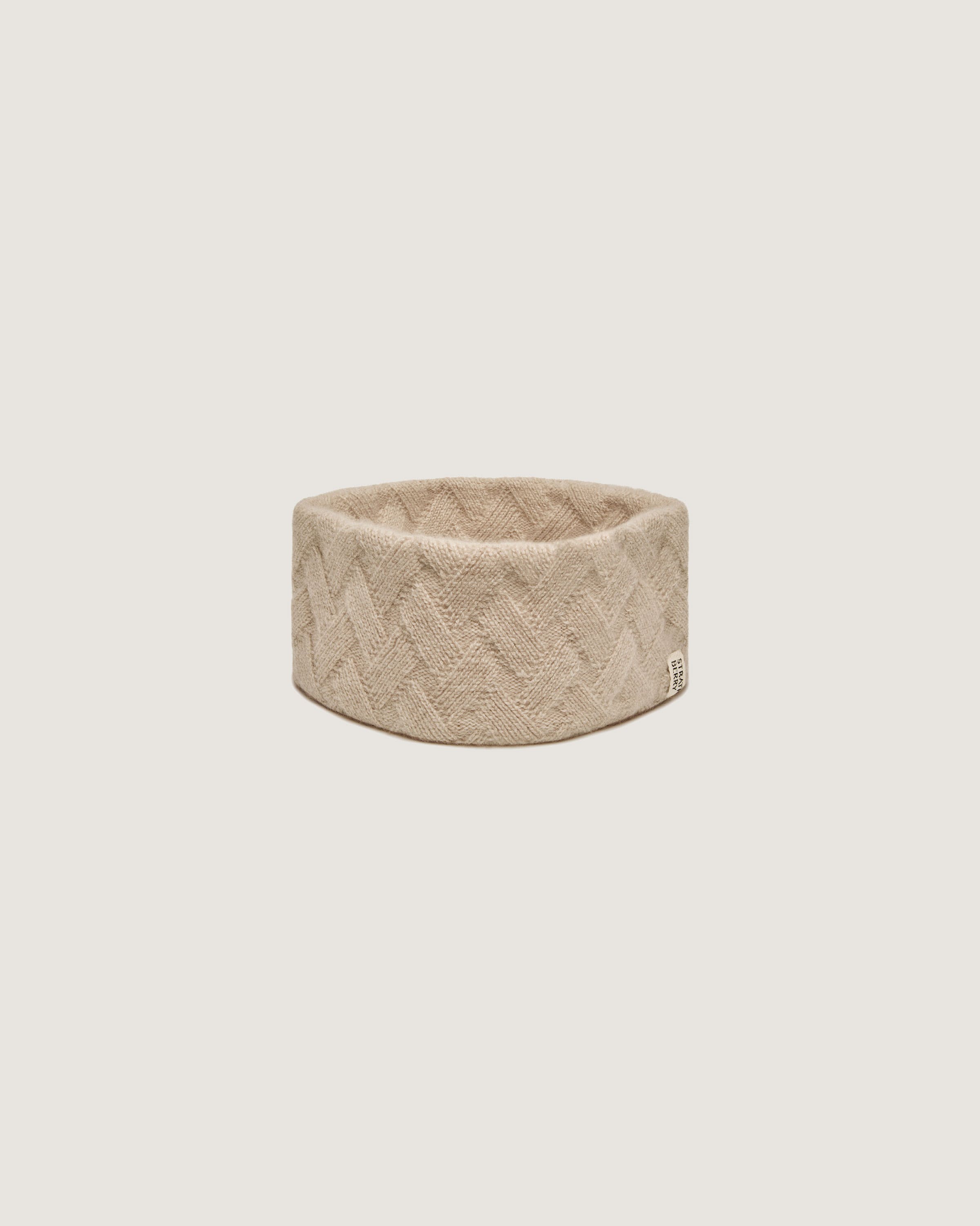 A beige ring on a white background