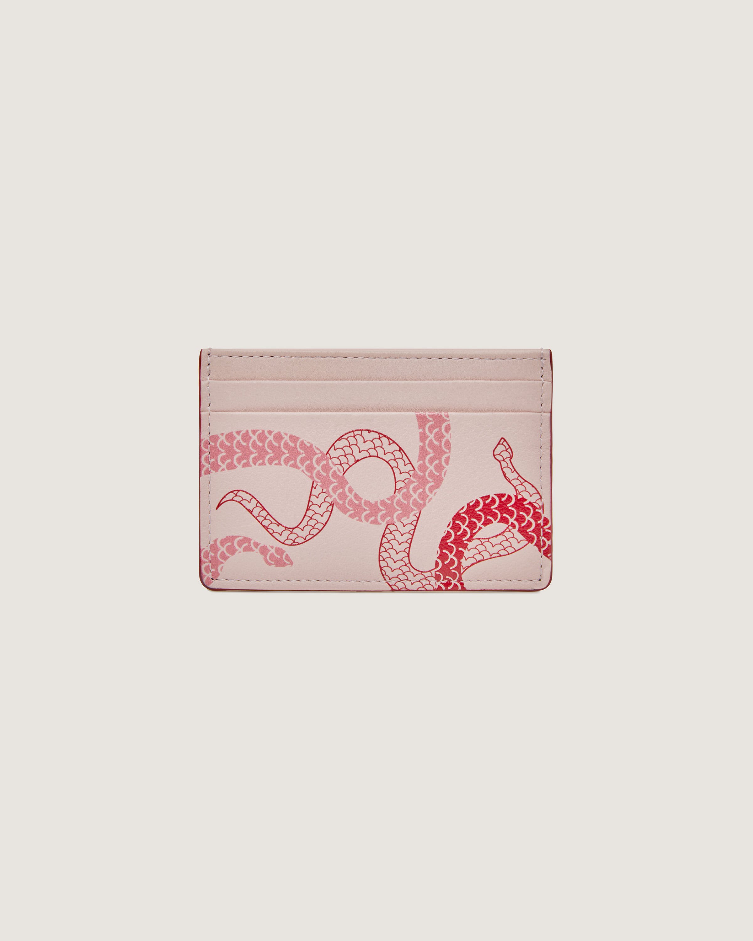 A pink card case with a snake on it