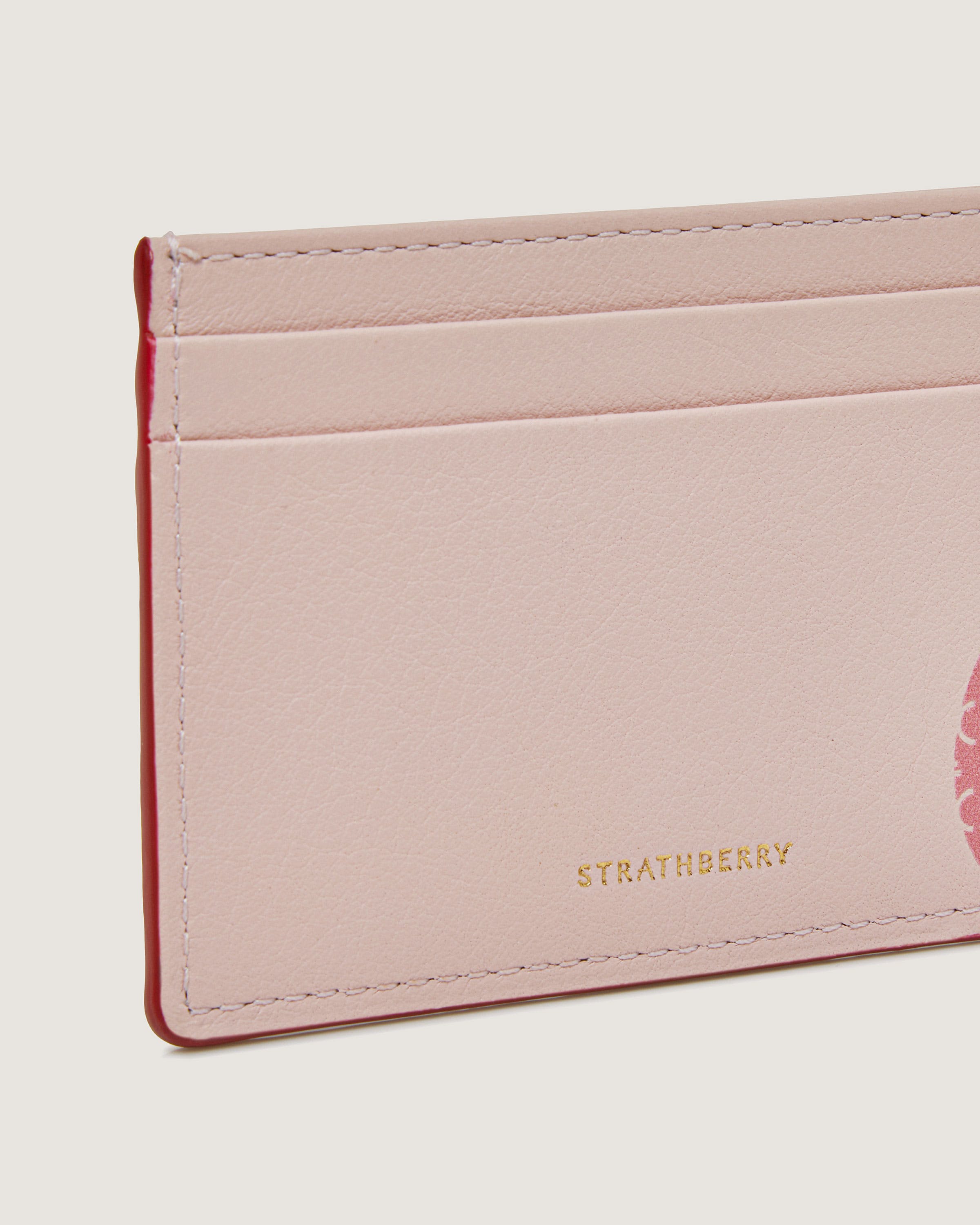 A pink card case with a pink flower on it