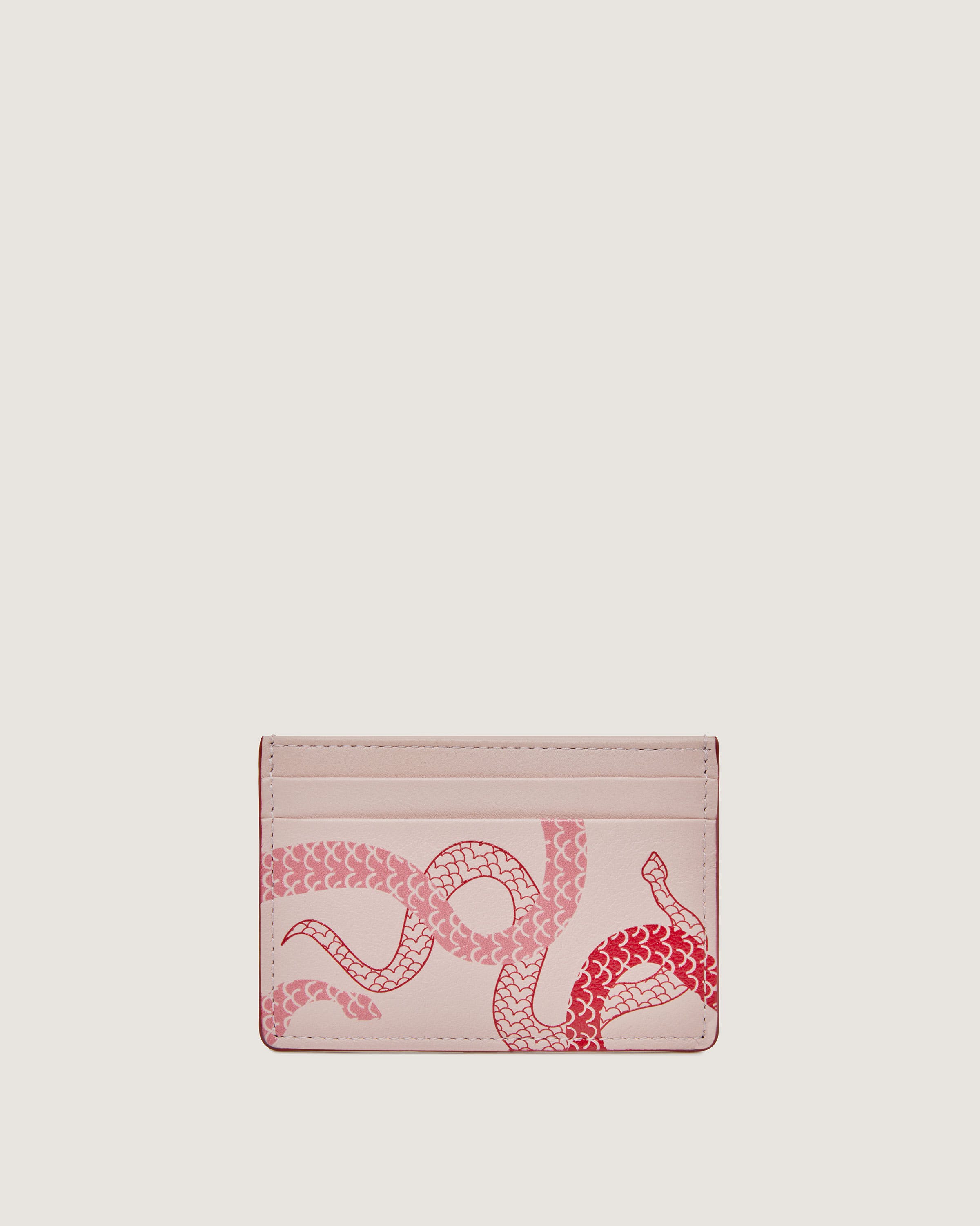 A pink card case with a snake on it