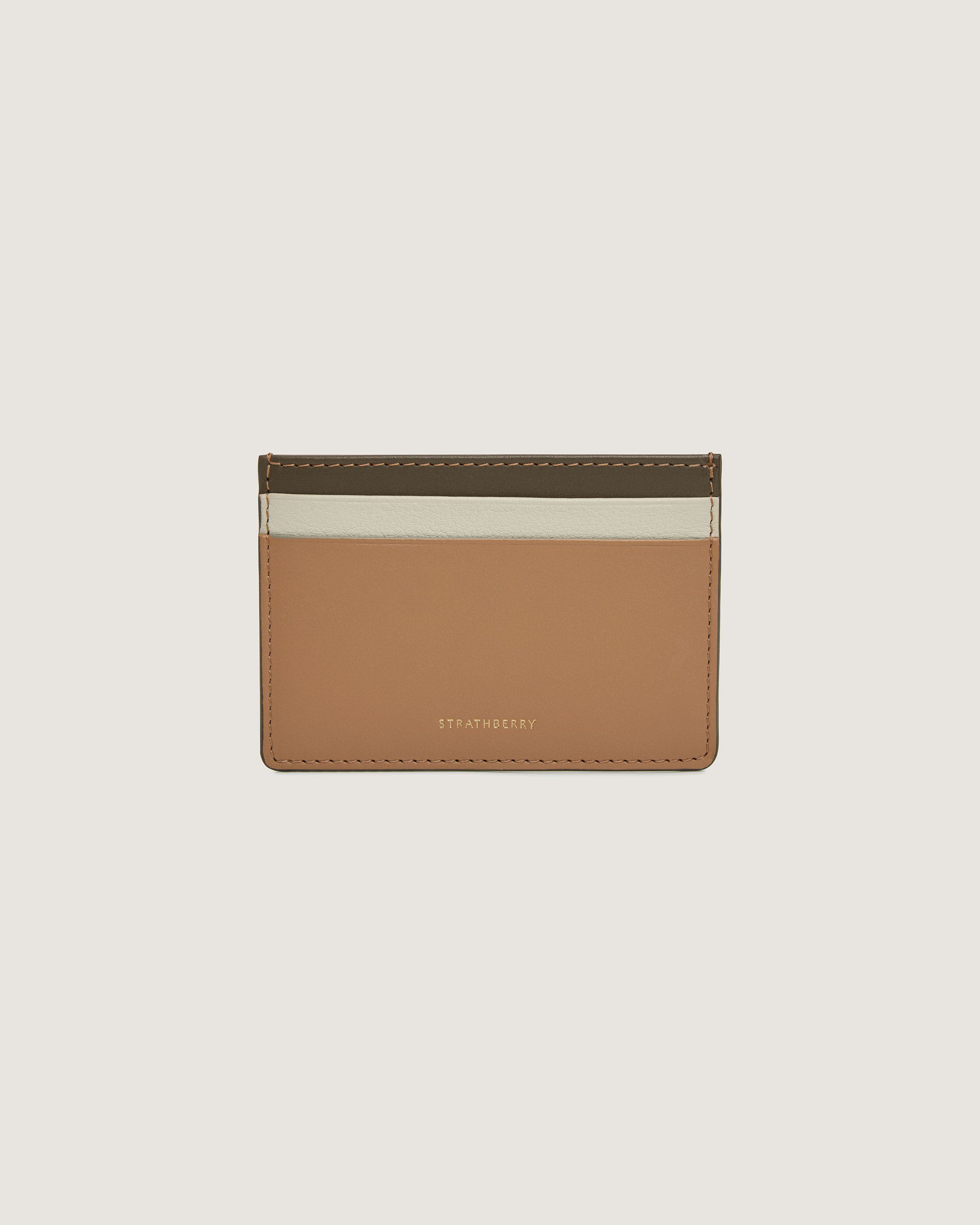 A tan and white card case on a white background