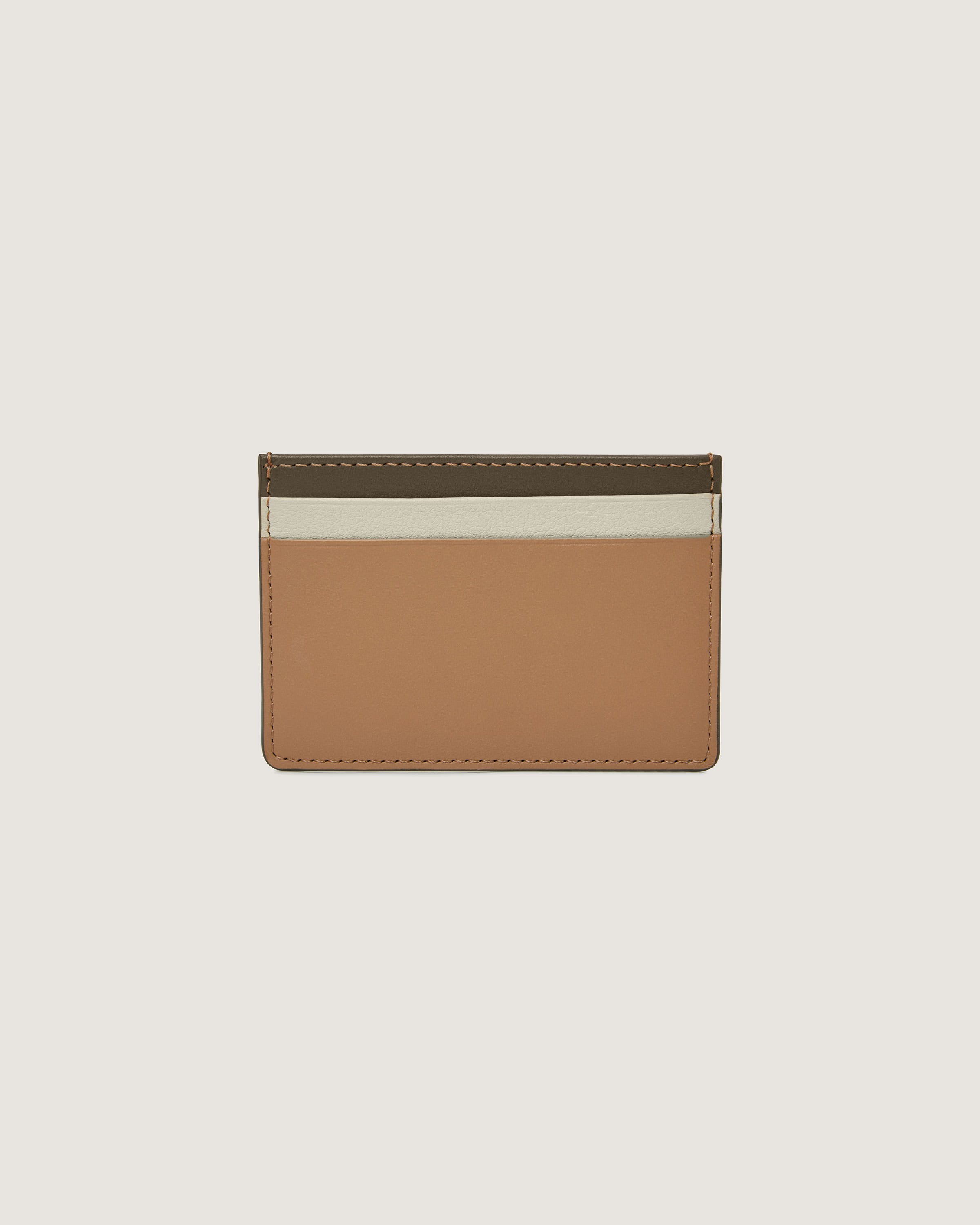 A tan and white card holder on a white background