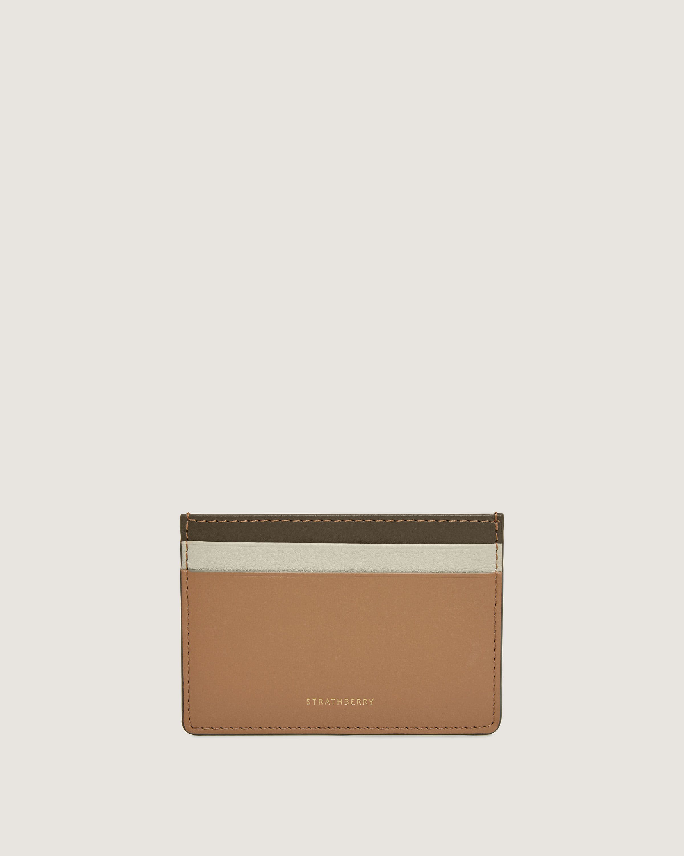 A tan card case with a white stripe