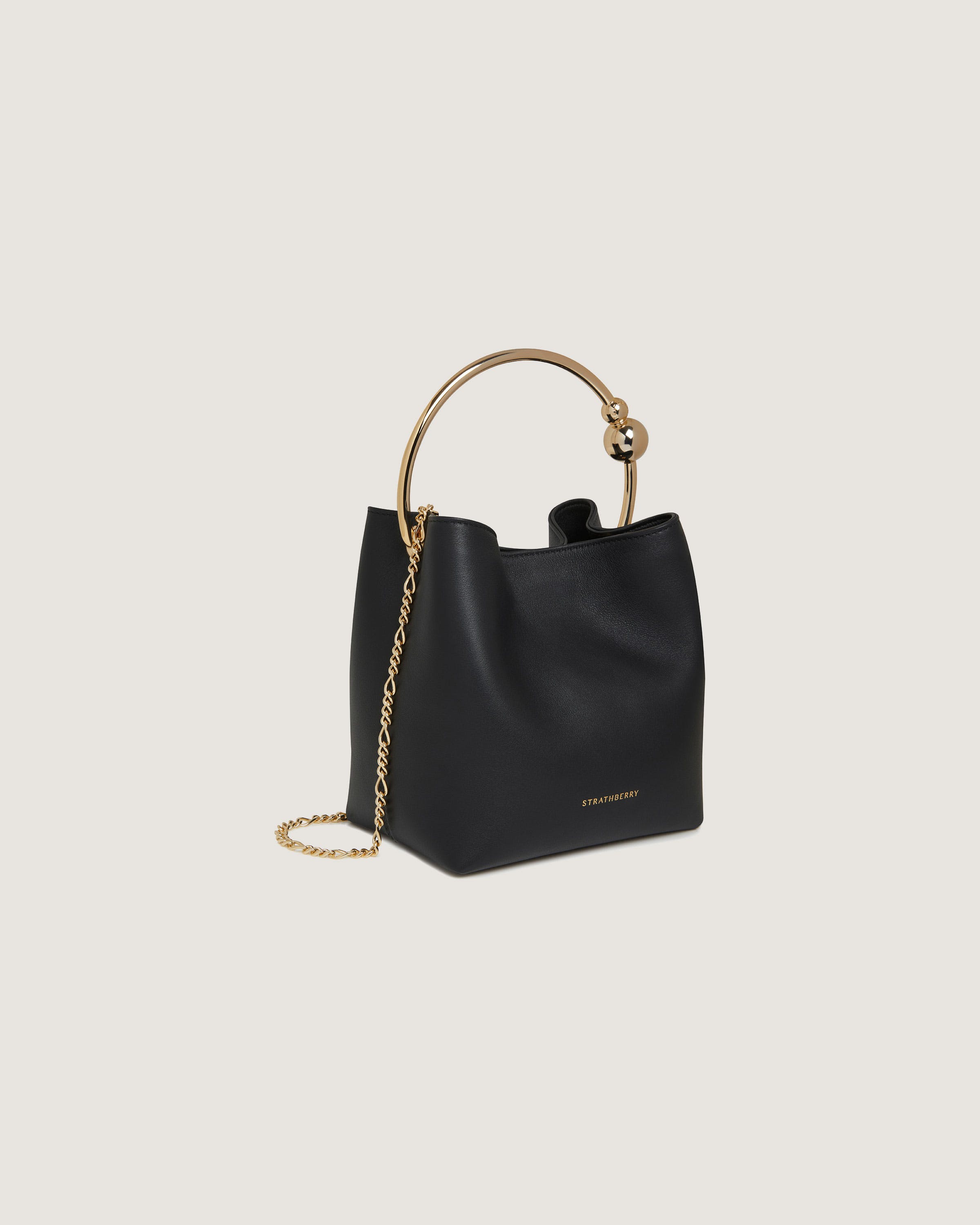 A black handbag with a gold handle