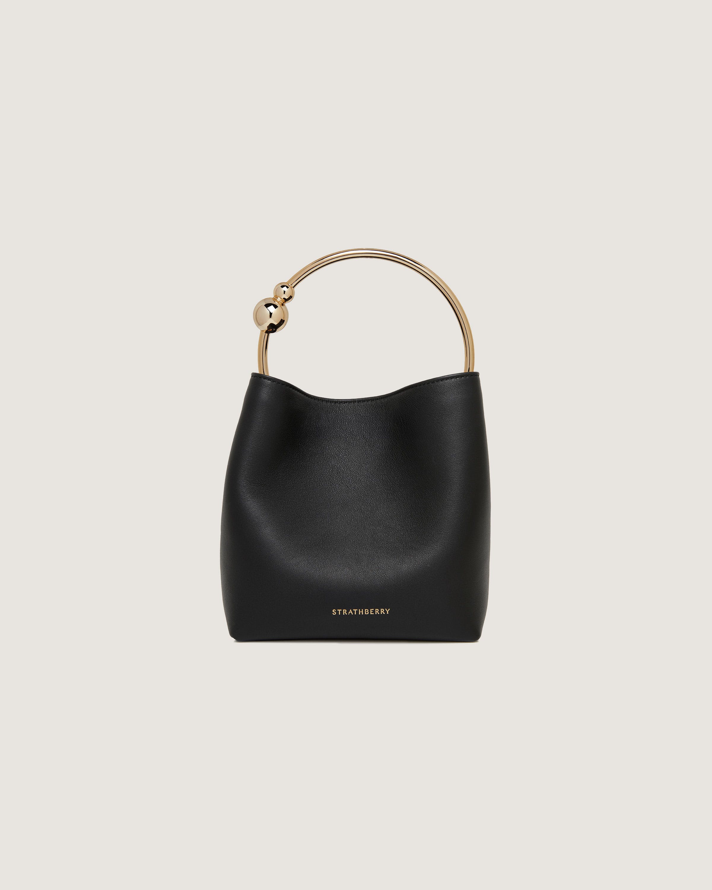 A black handbag with a gold handle