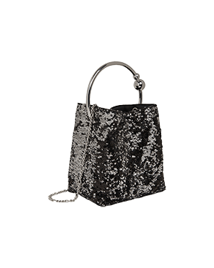 A black and white handbag on a green background