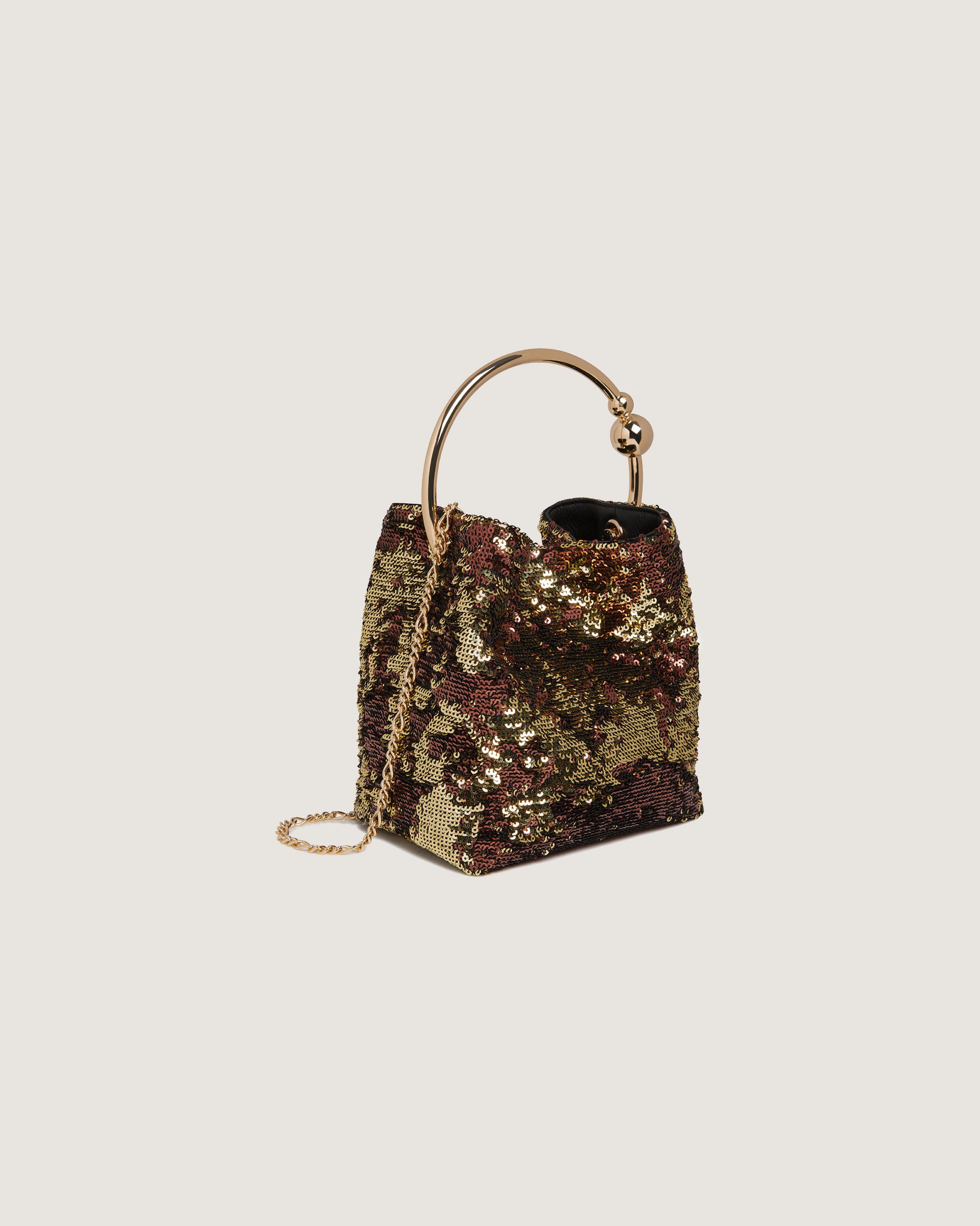 A handbag with a gold sequinized handle