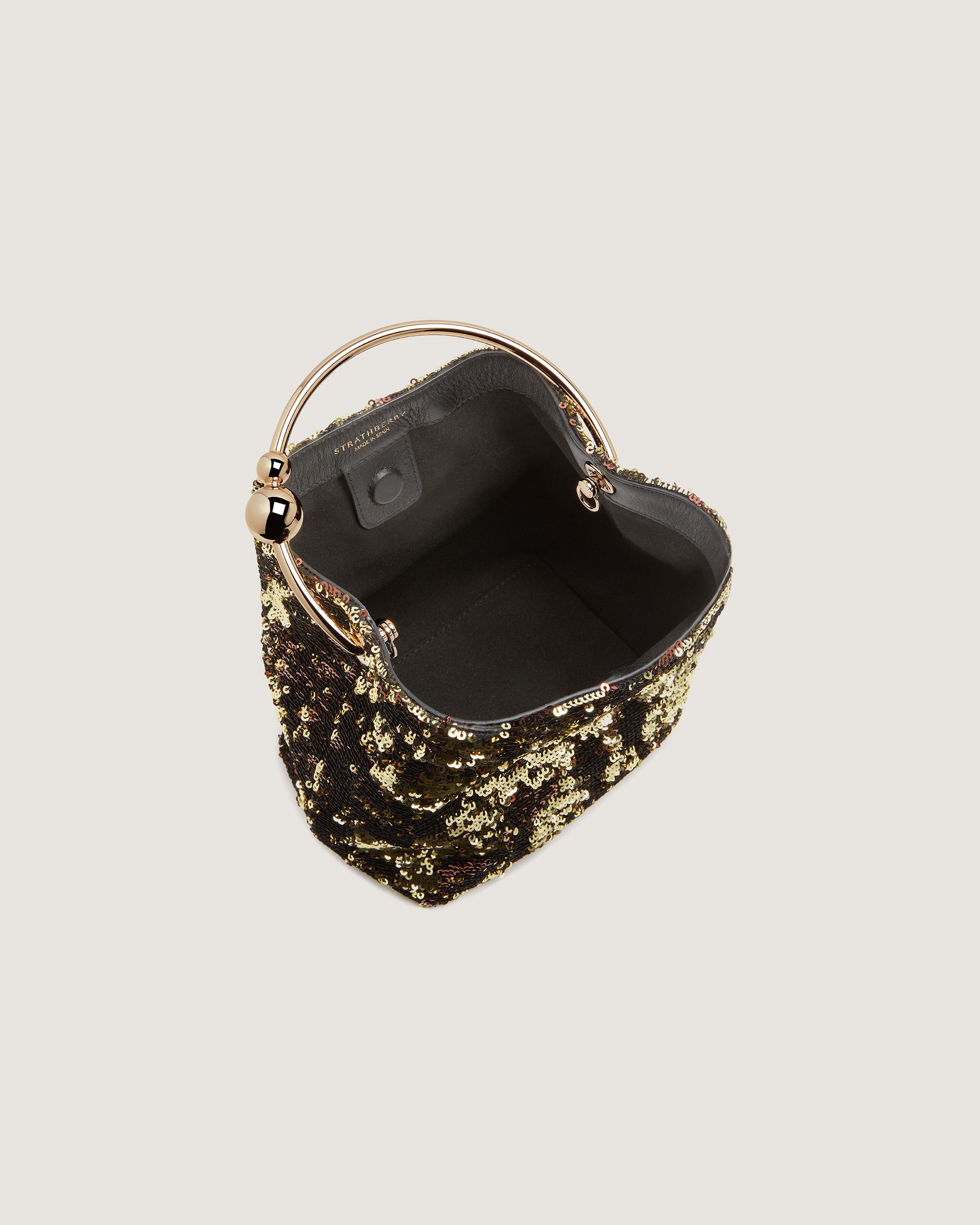 A black and gold handbag with a handle