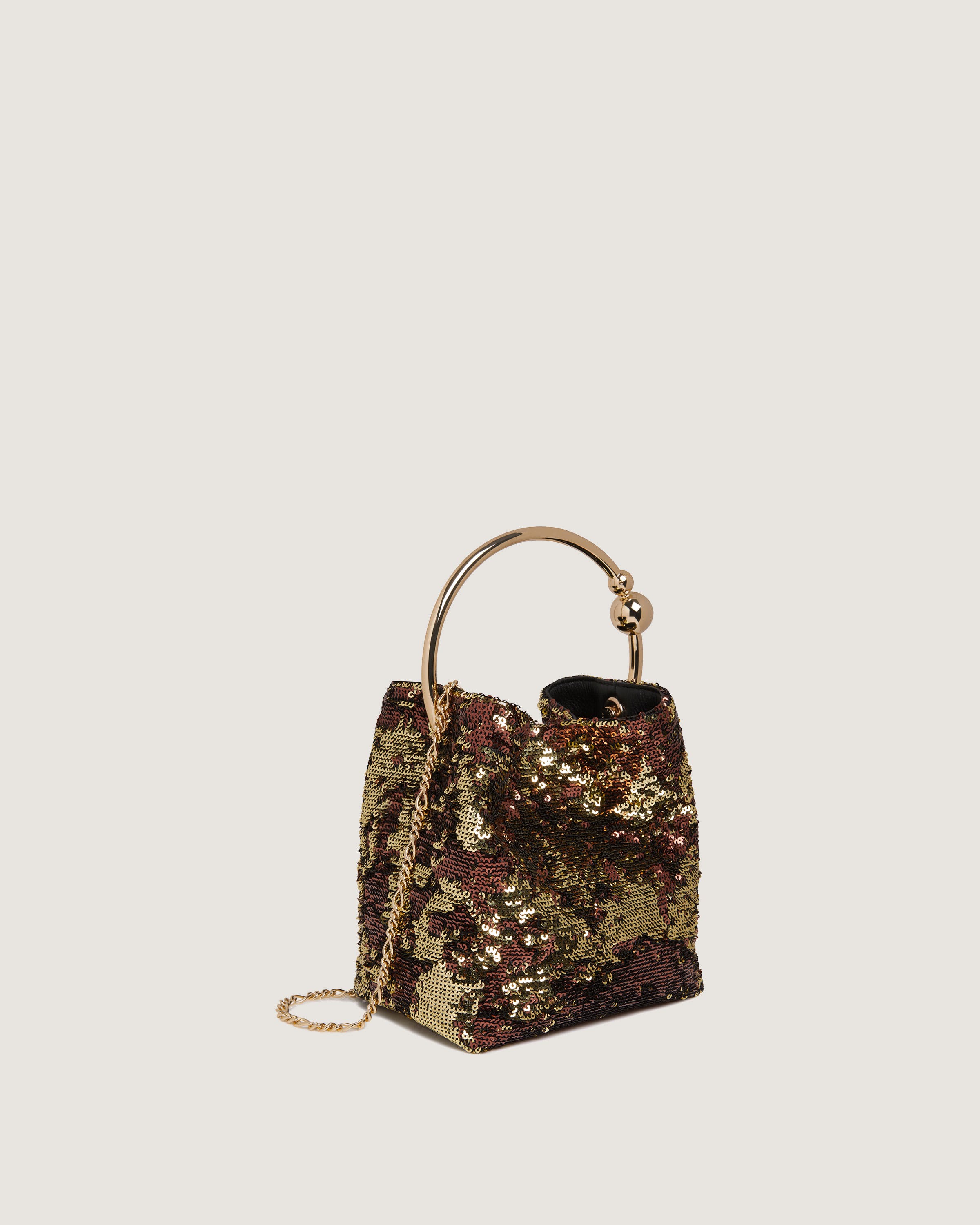 A handbag with a gold sequinized handle