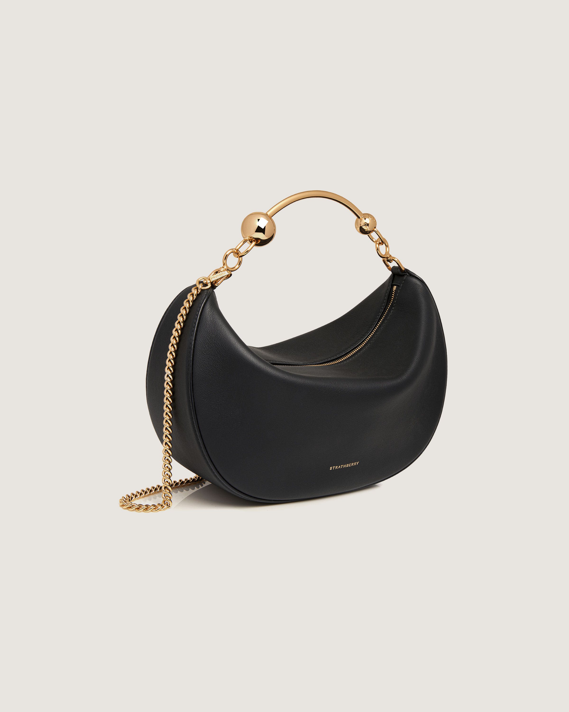 A black handbag with a gold chain strap