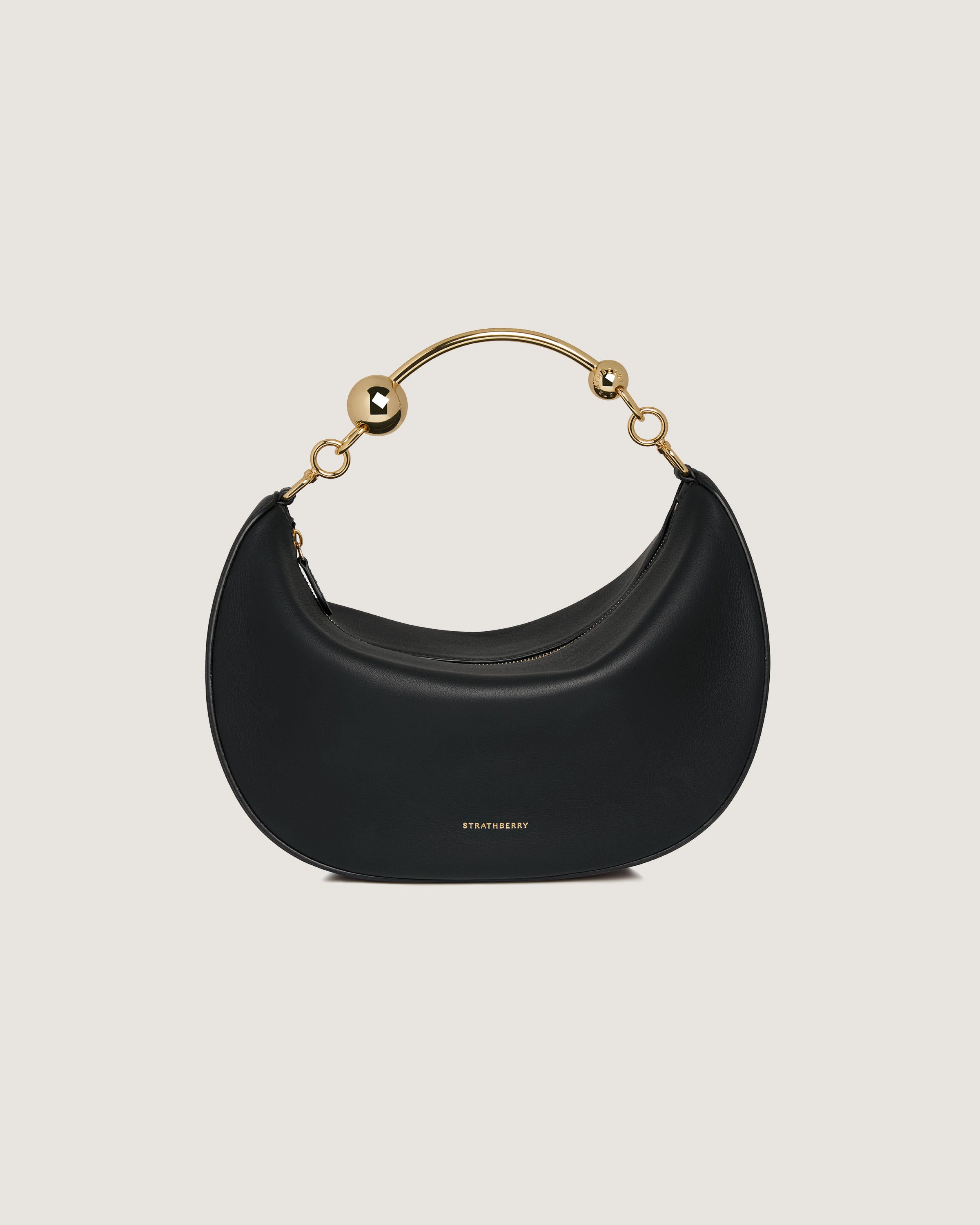 A black purse with a gold handle