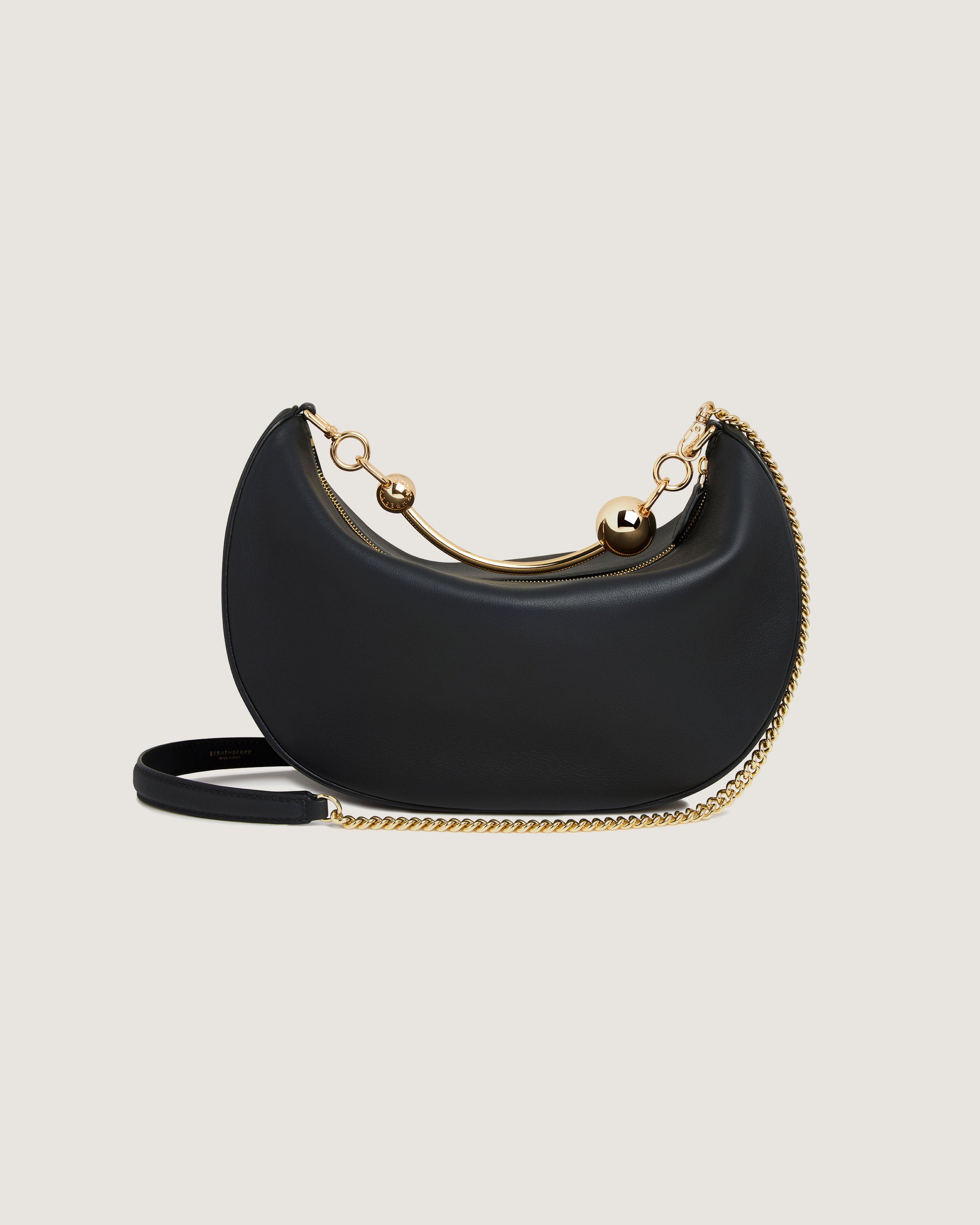 A black purse with a gold chain strap