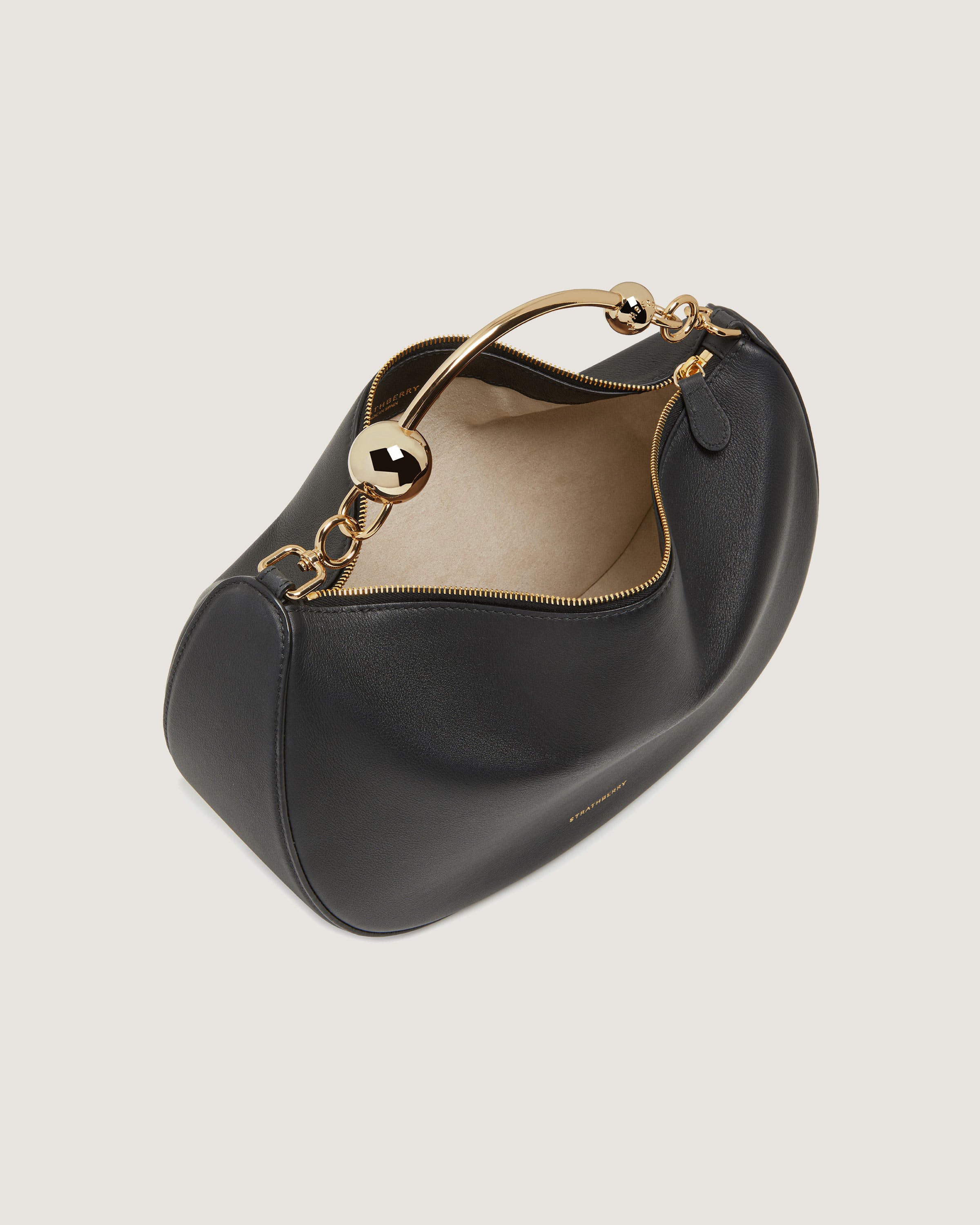 A black handbag with a gold handle