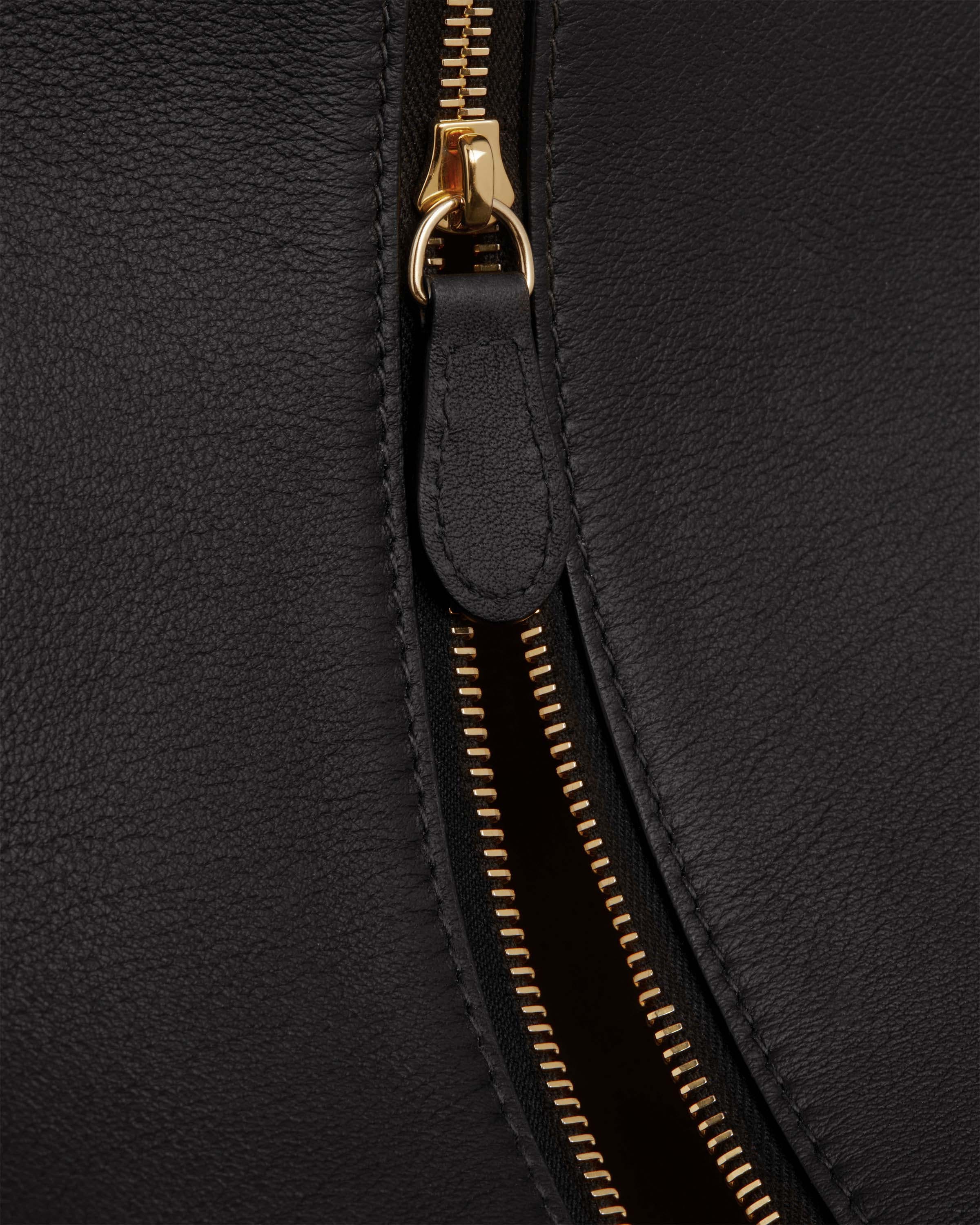 A close up of a black leather purse