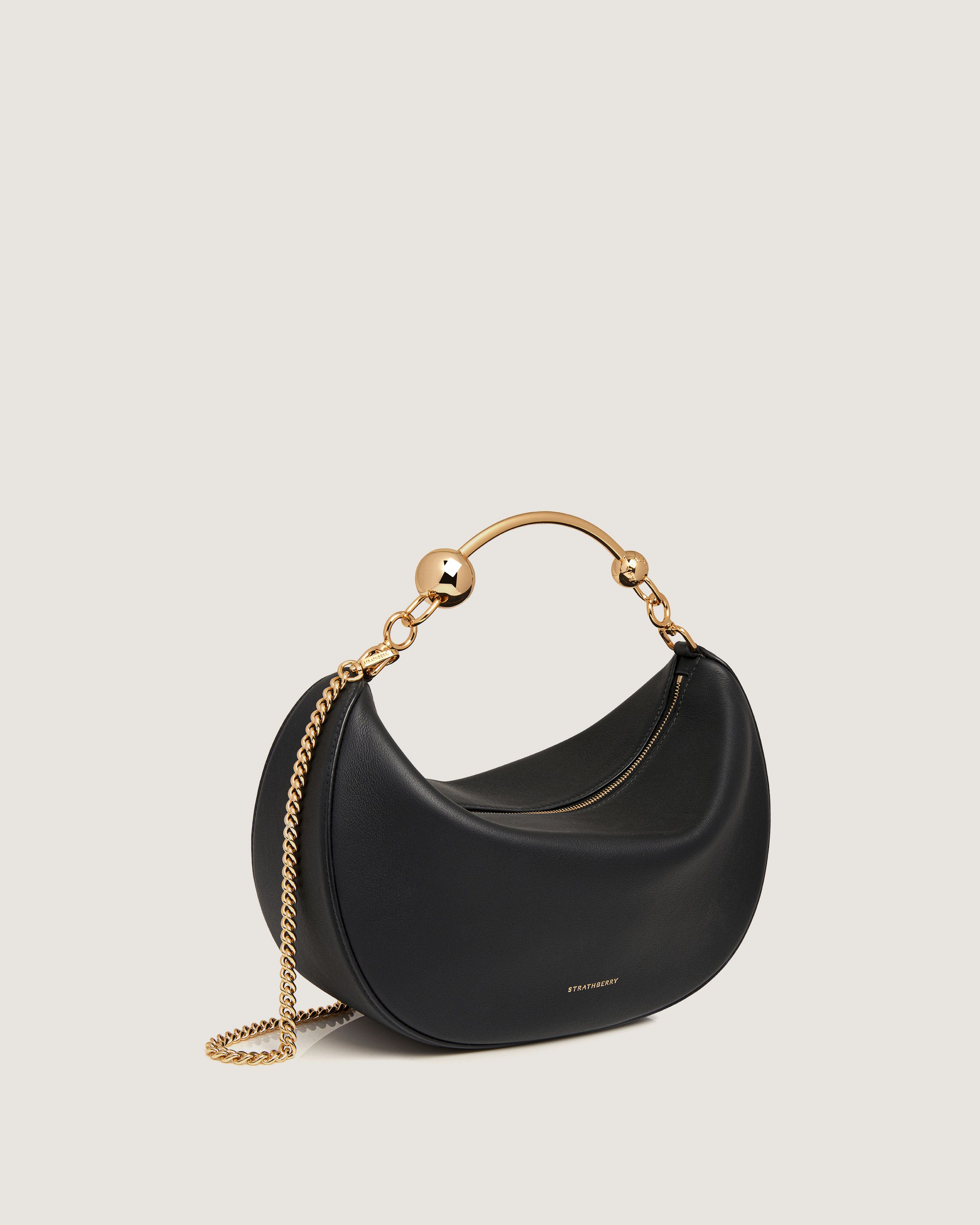 A black handbag with a gold chain