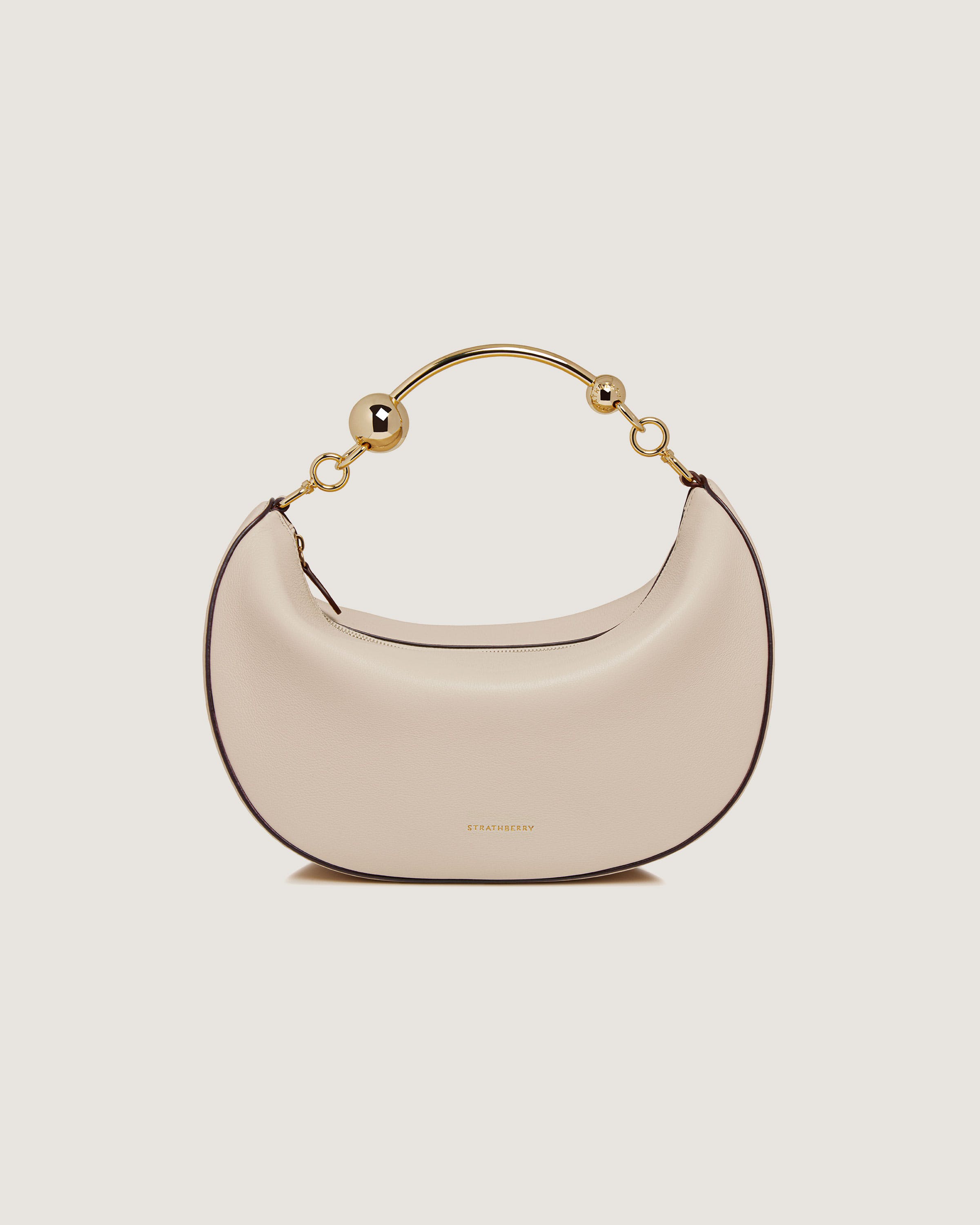 A white purse with a gold handle