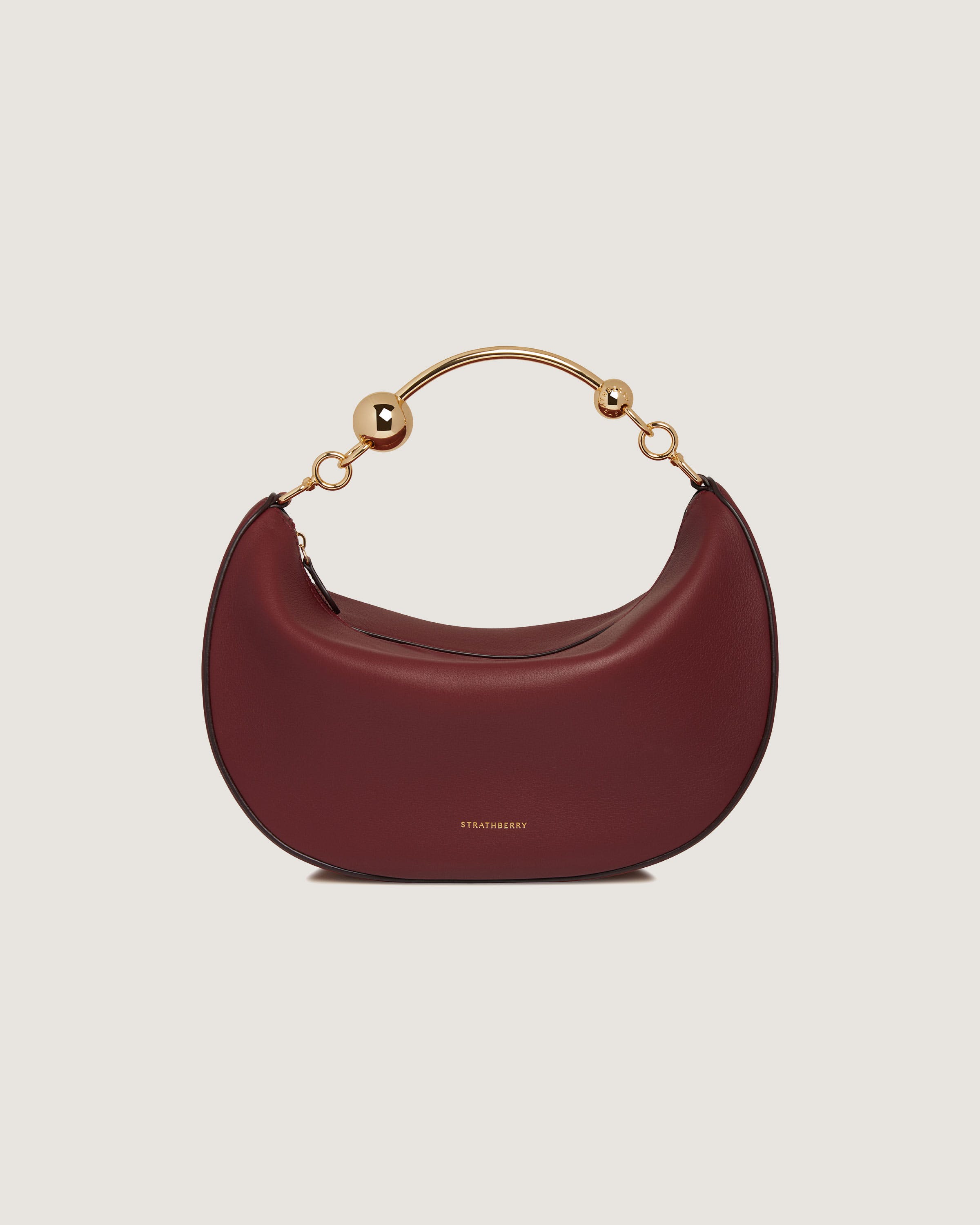 A red handbag with a gold handle