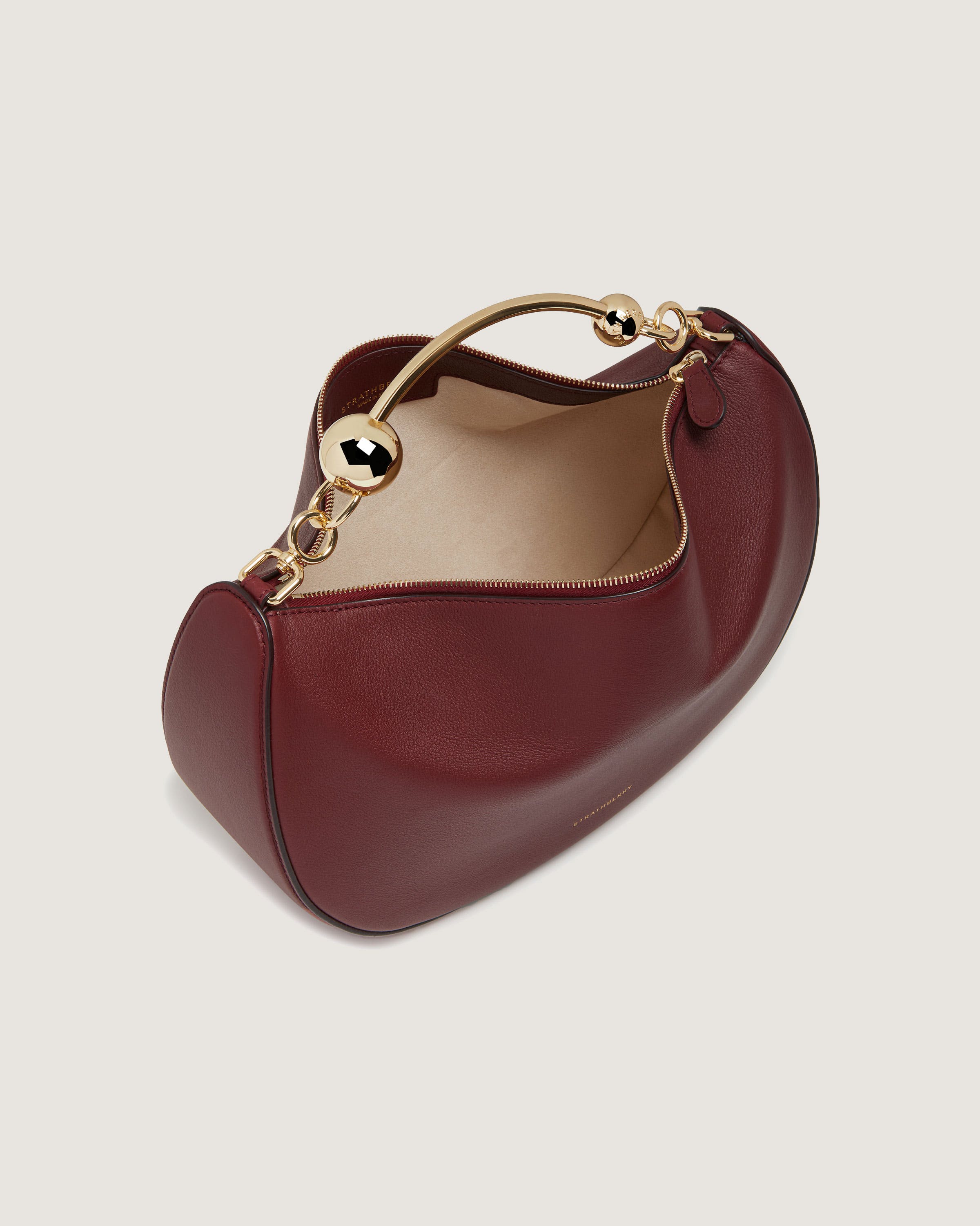 A red handbag with a gold handle