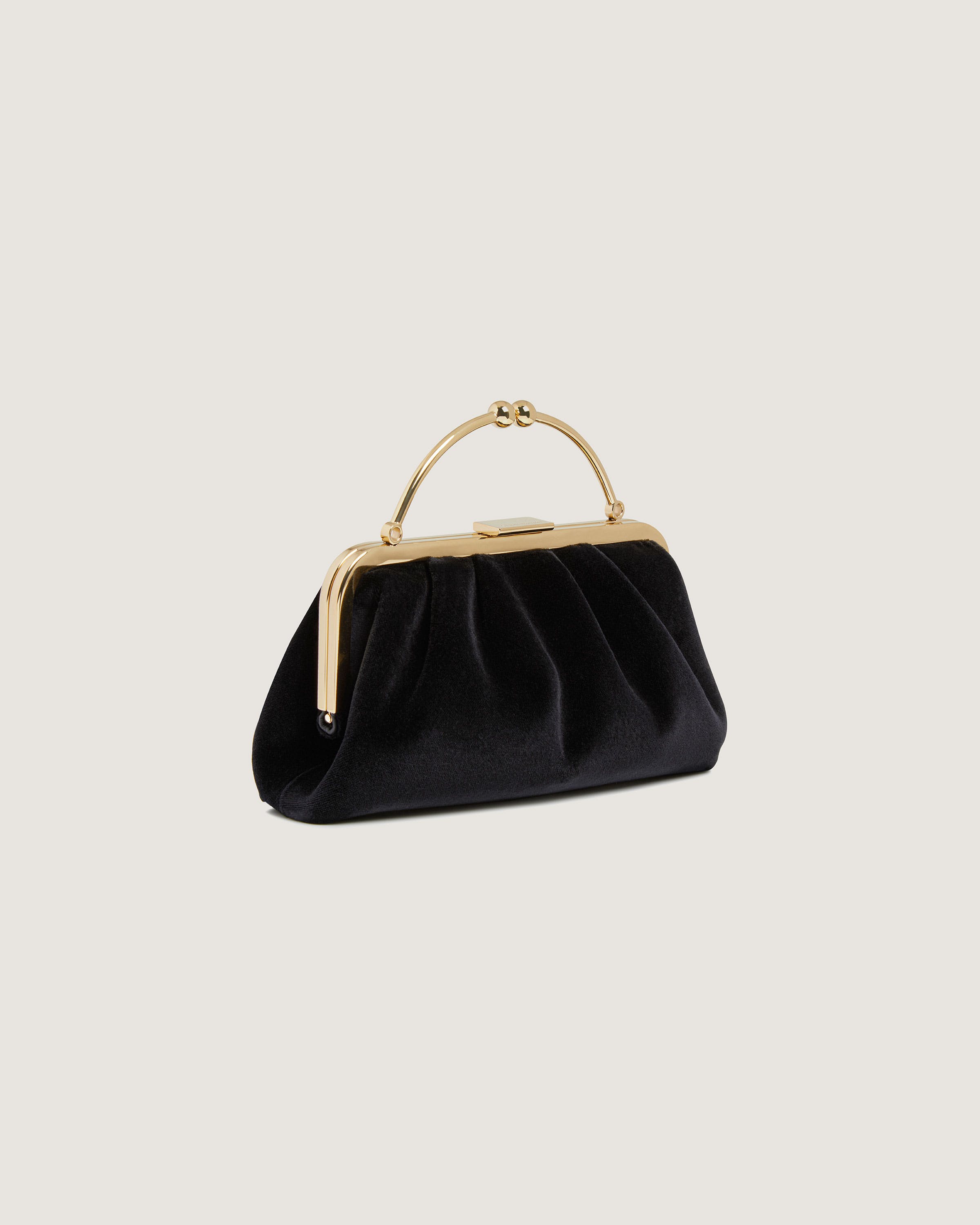 A black purse with a gold handle