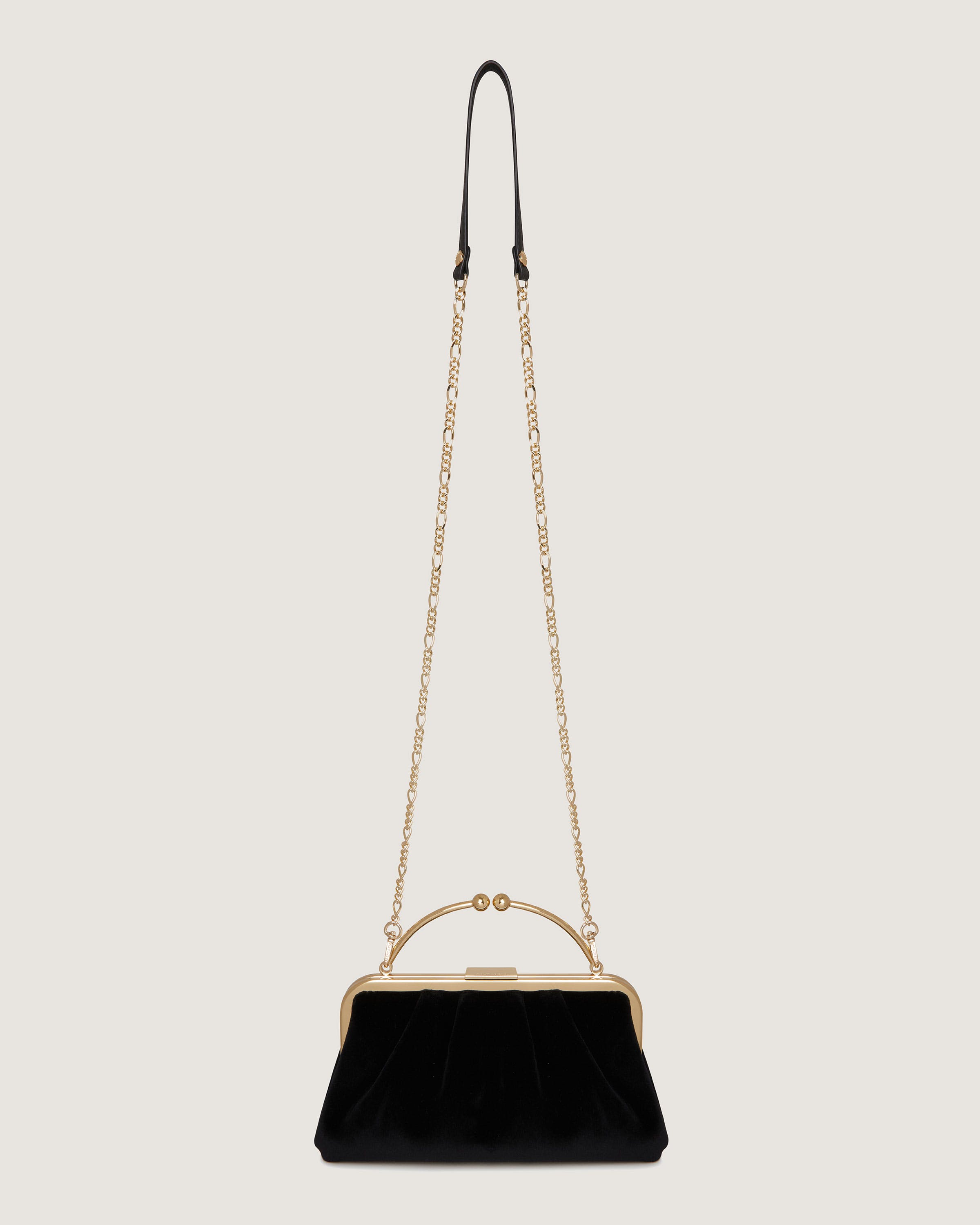 A black velvet handbag with a chain strap