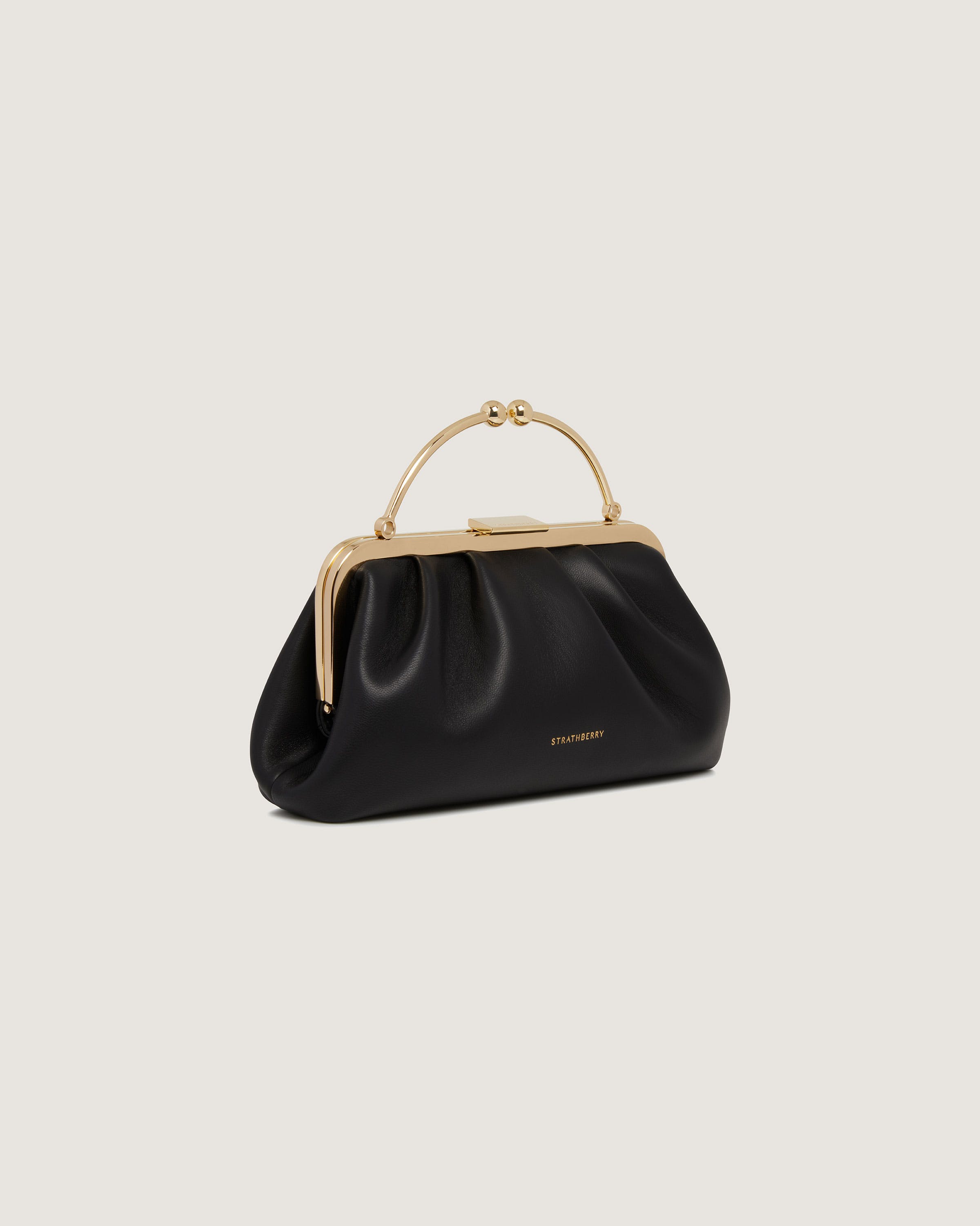 A black handbag with a gold handle