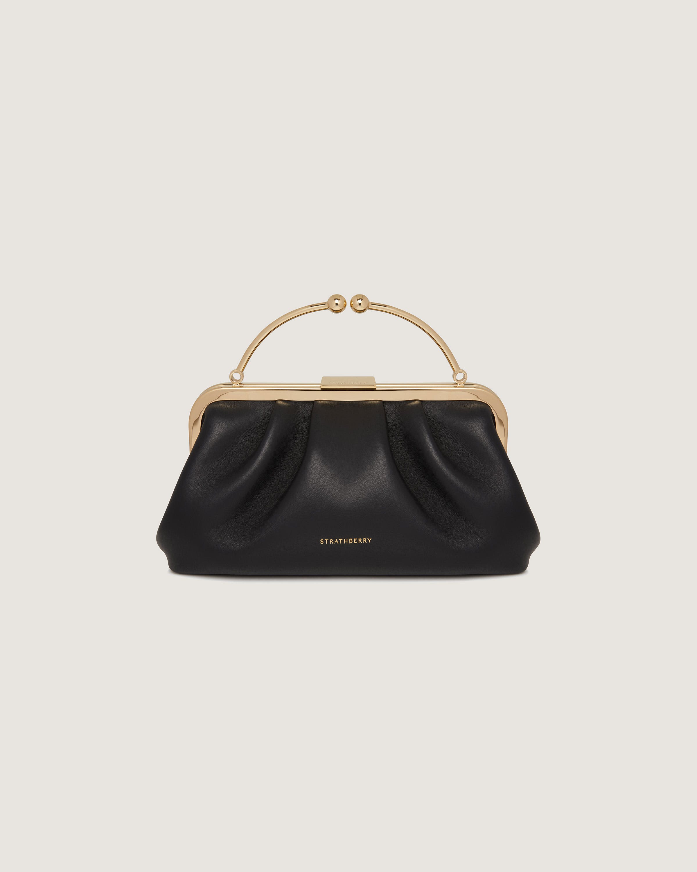 A black handbag with a gold handle