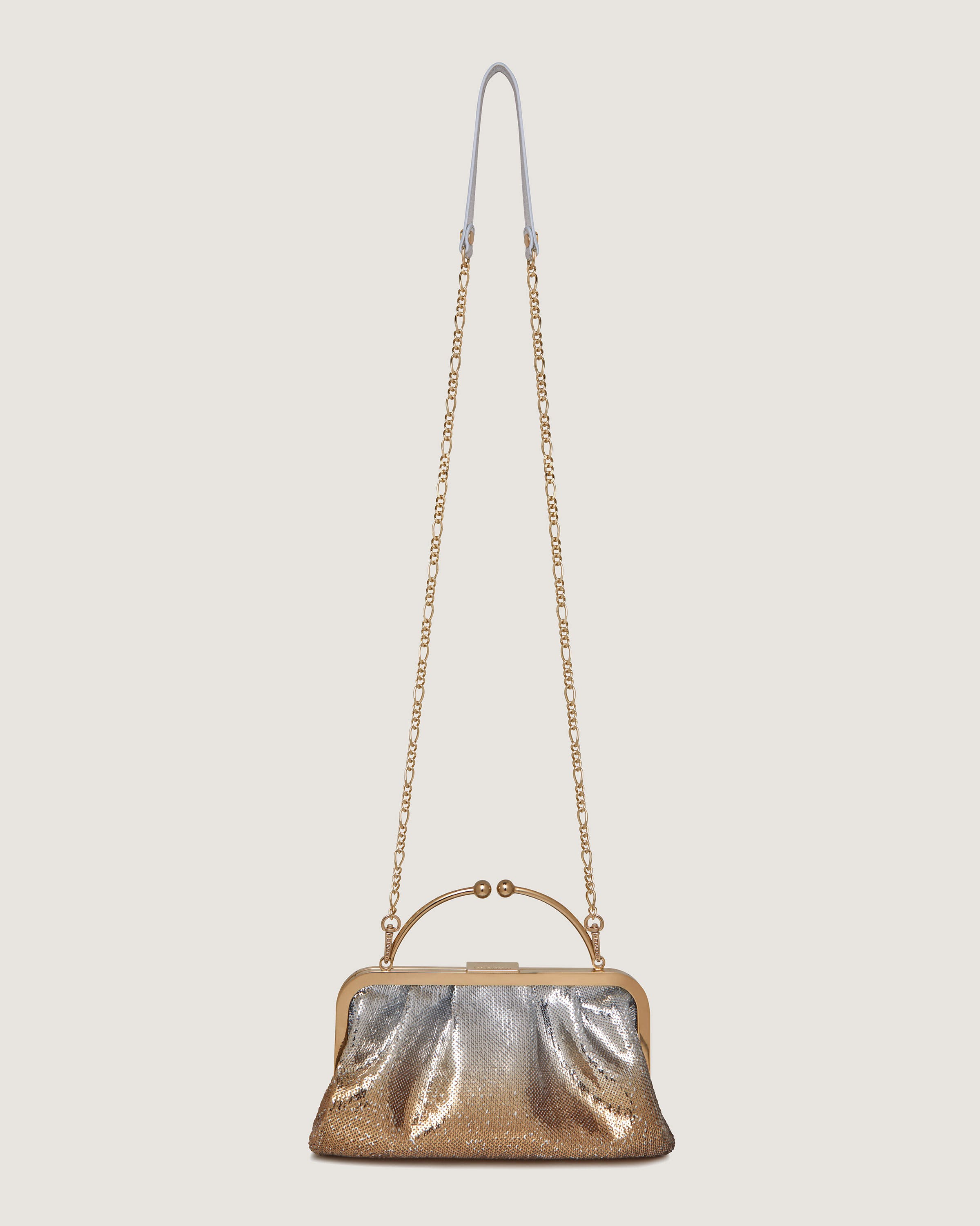 A gold purse with a chain hanging from it