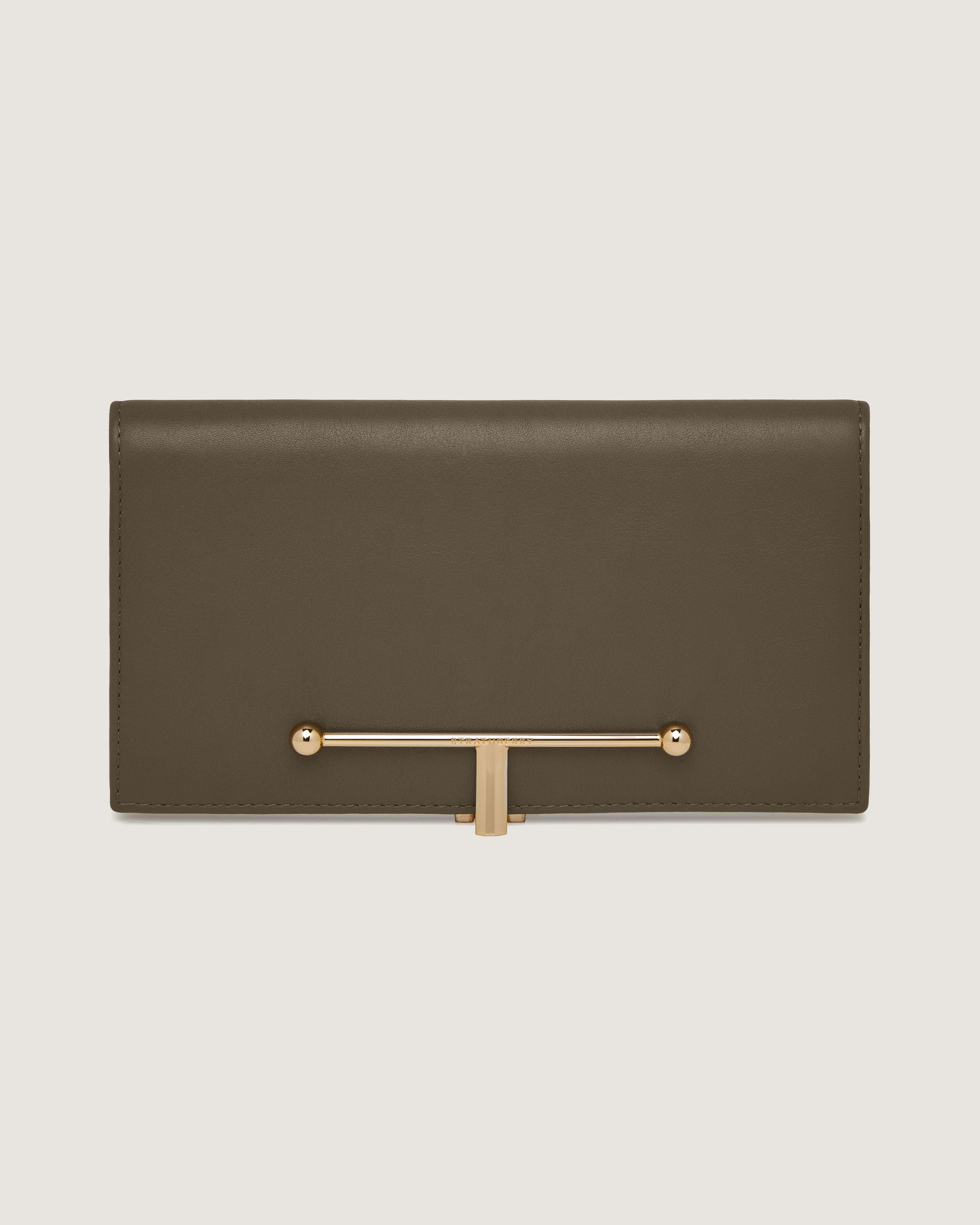 A brown leather clutch bag with a gold handle