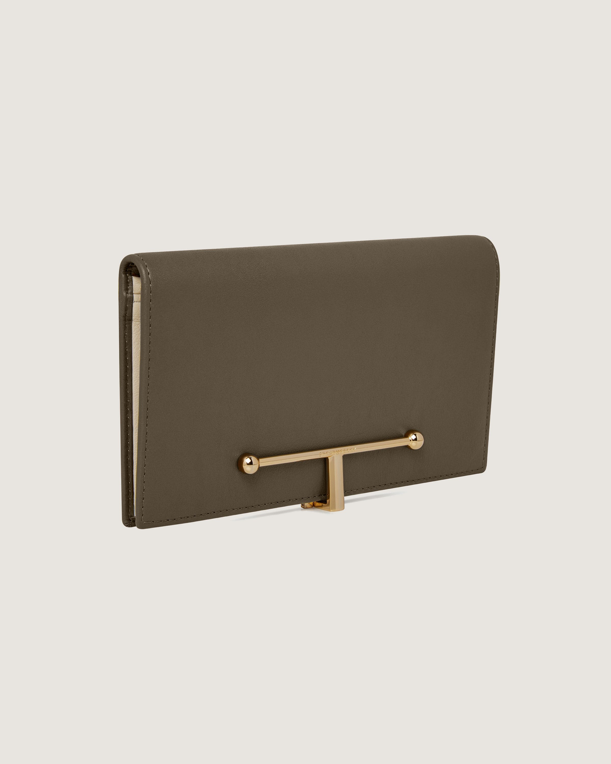 A brown clutch bag with a gold handle