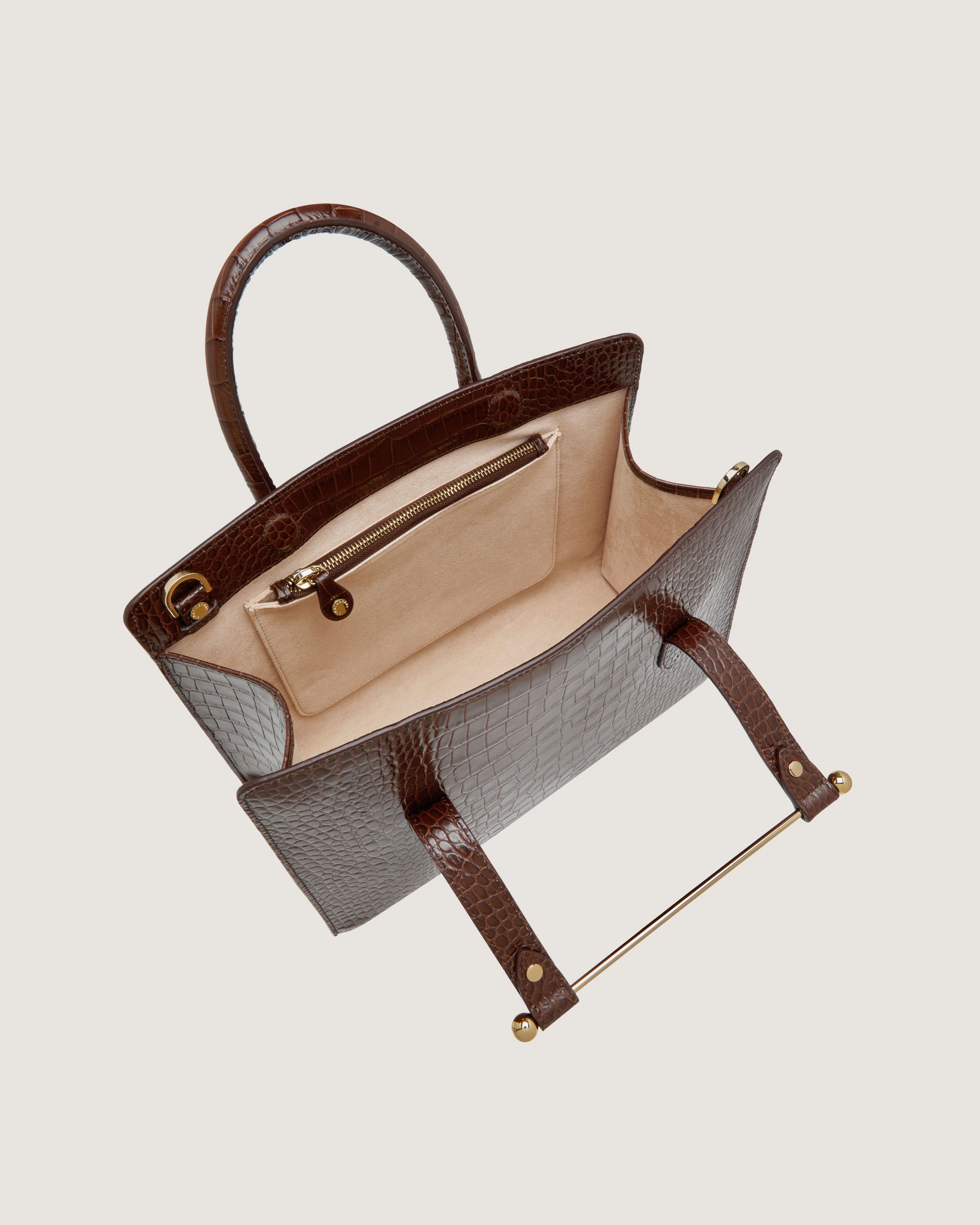 A brown and white purse with a handle