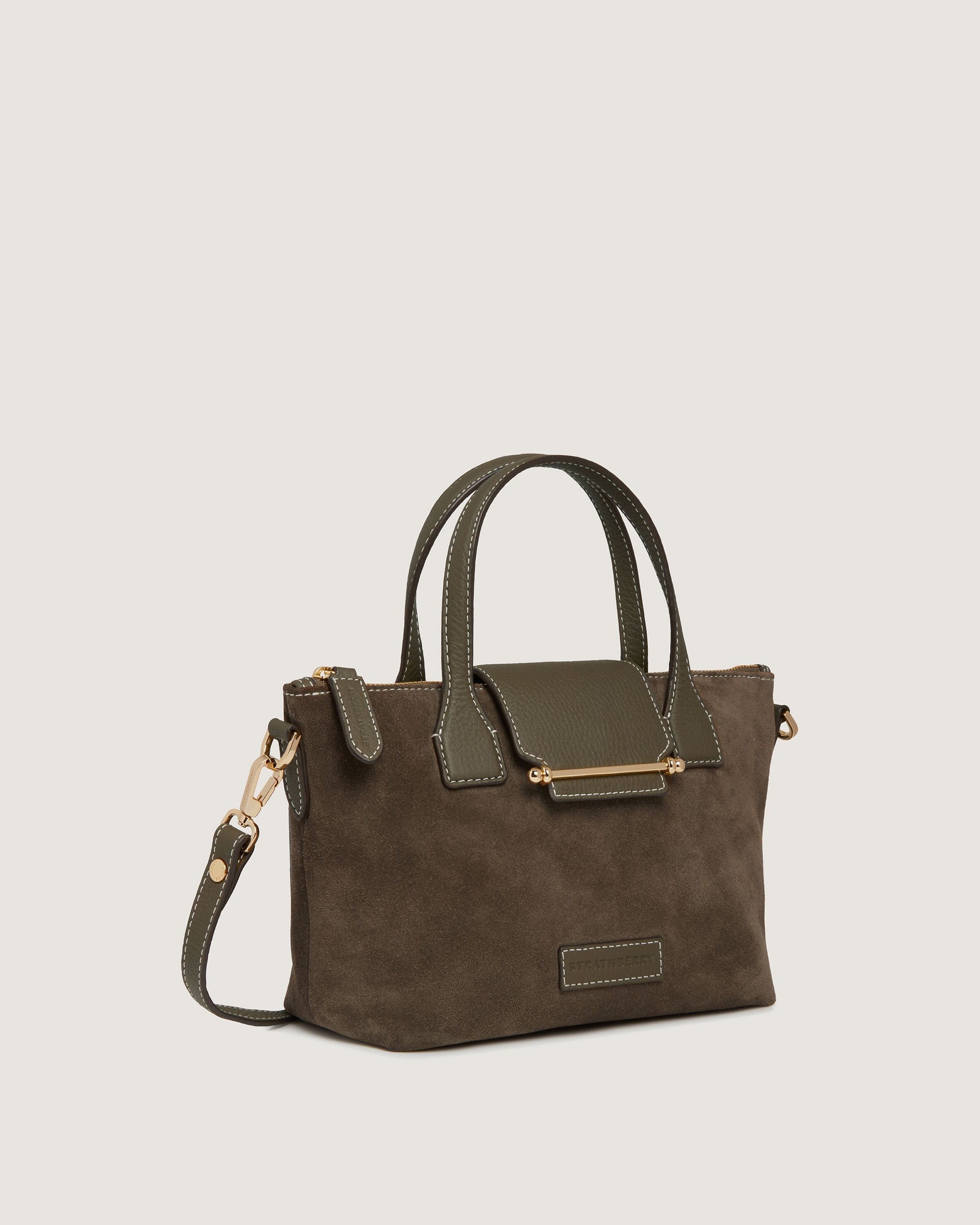 A brown handbag with a gold handle