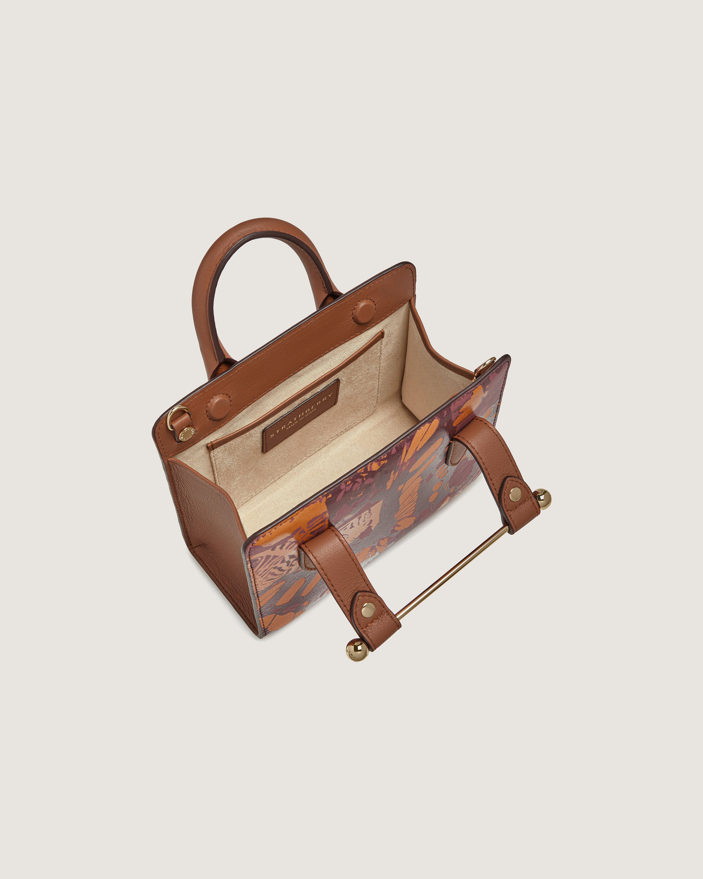 A brown handbag with a handle and handles