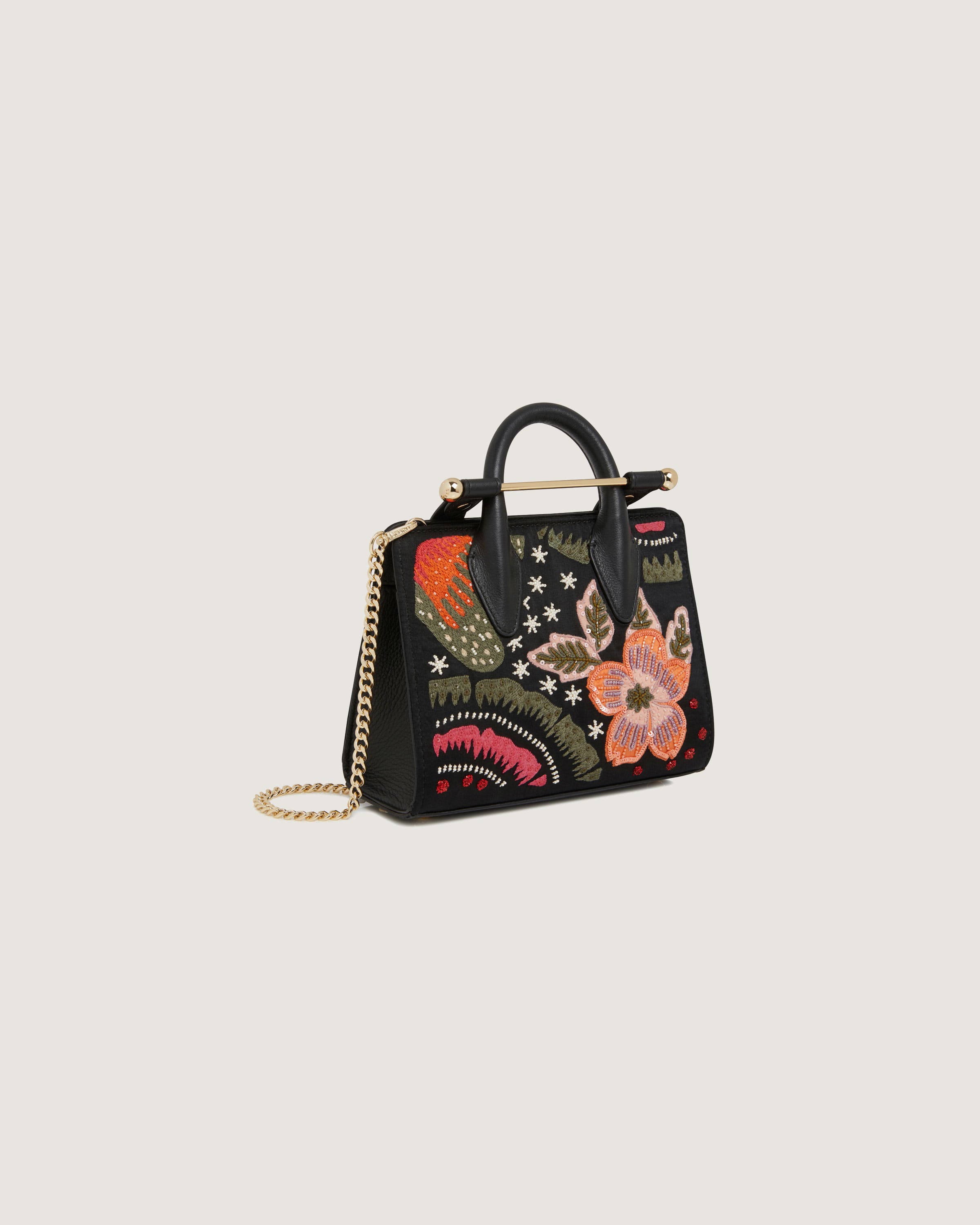 A black handbag with a floral design