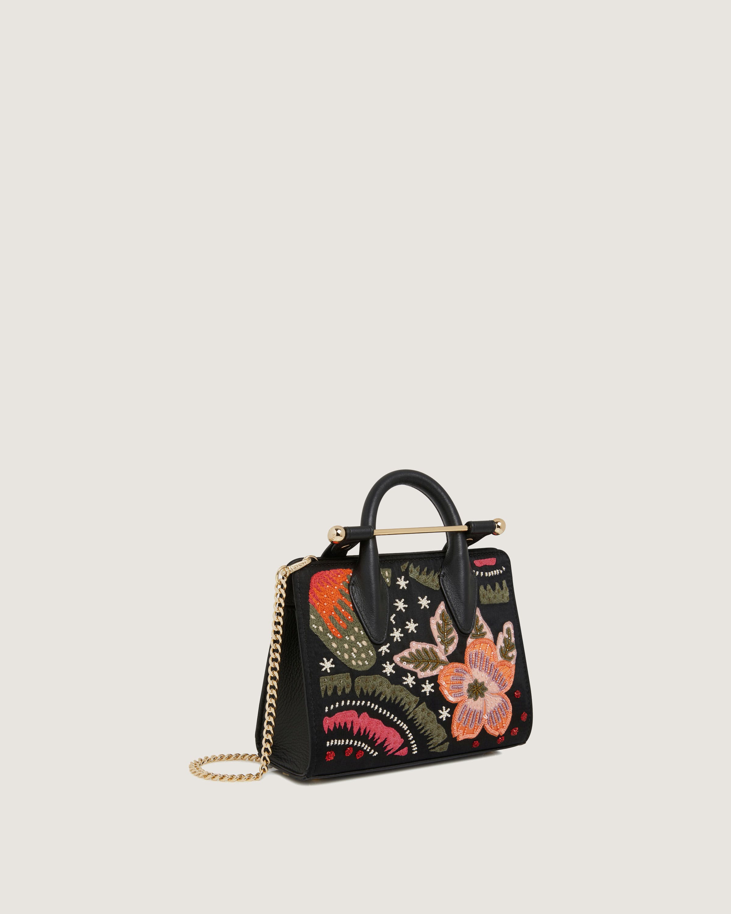 A black handbag with a floral design