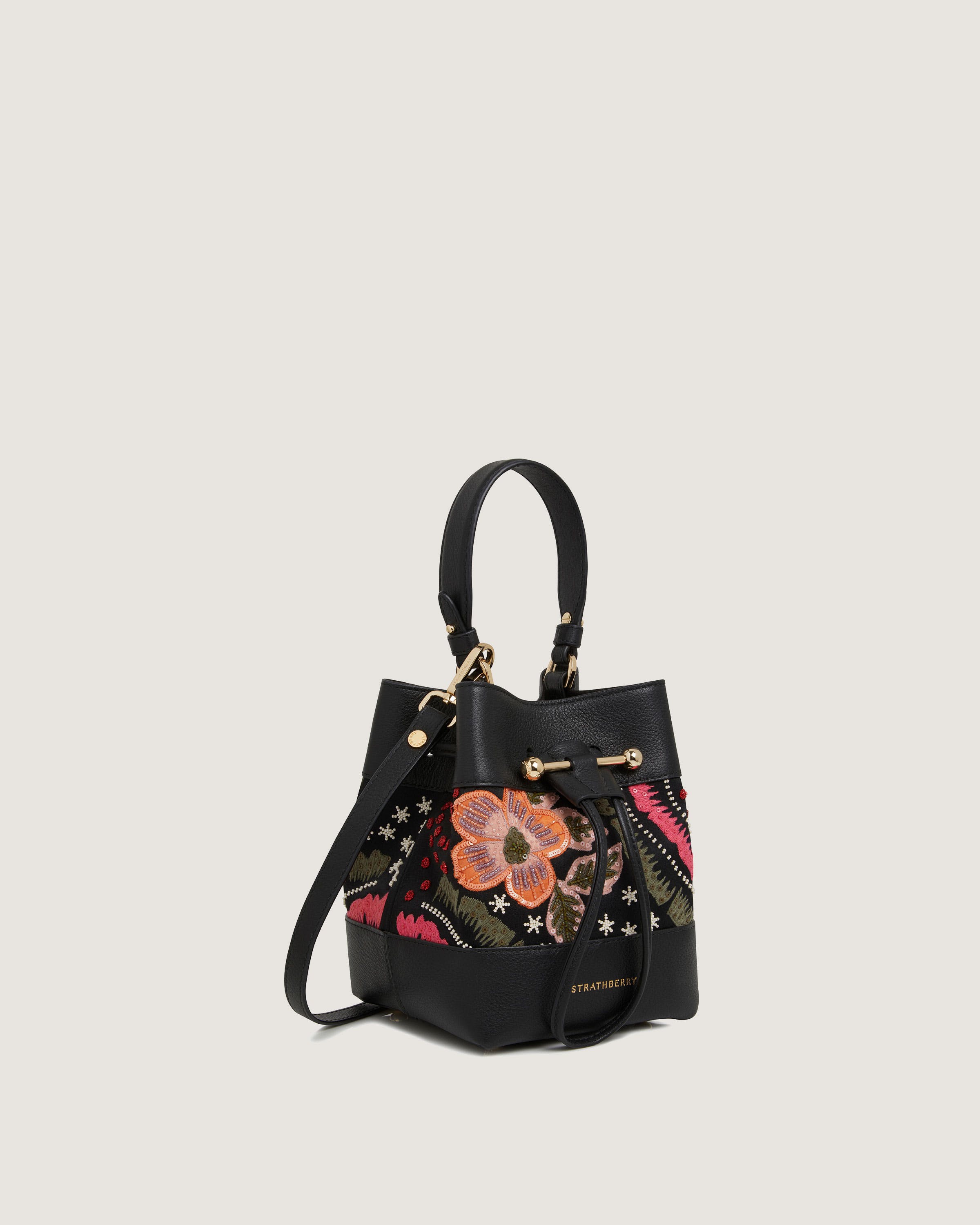 A black handbag with a flower on it