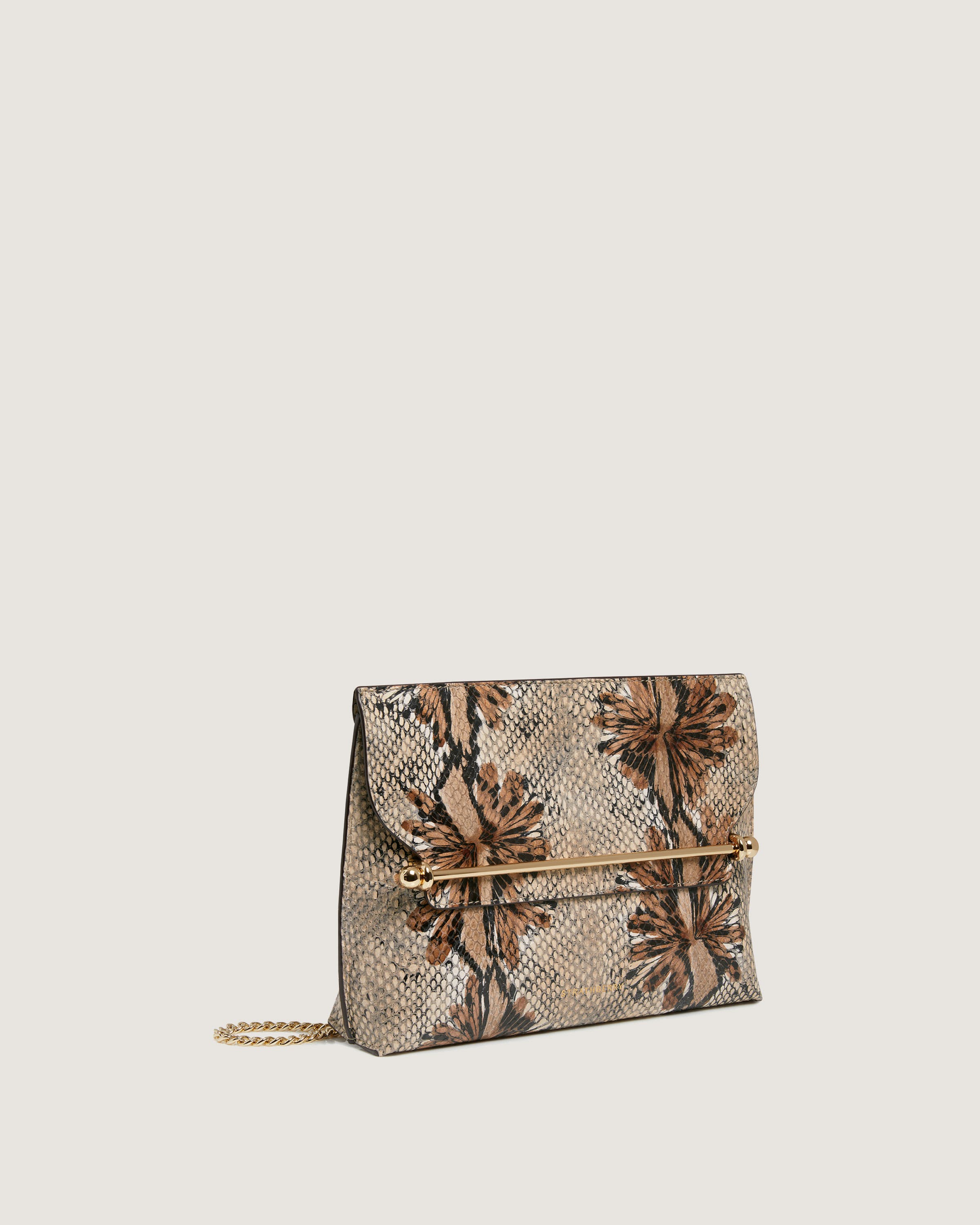 A snake skin purse with flowers on it