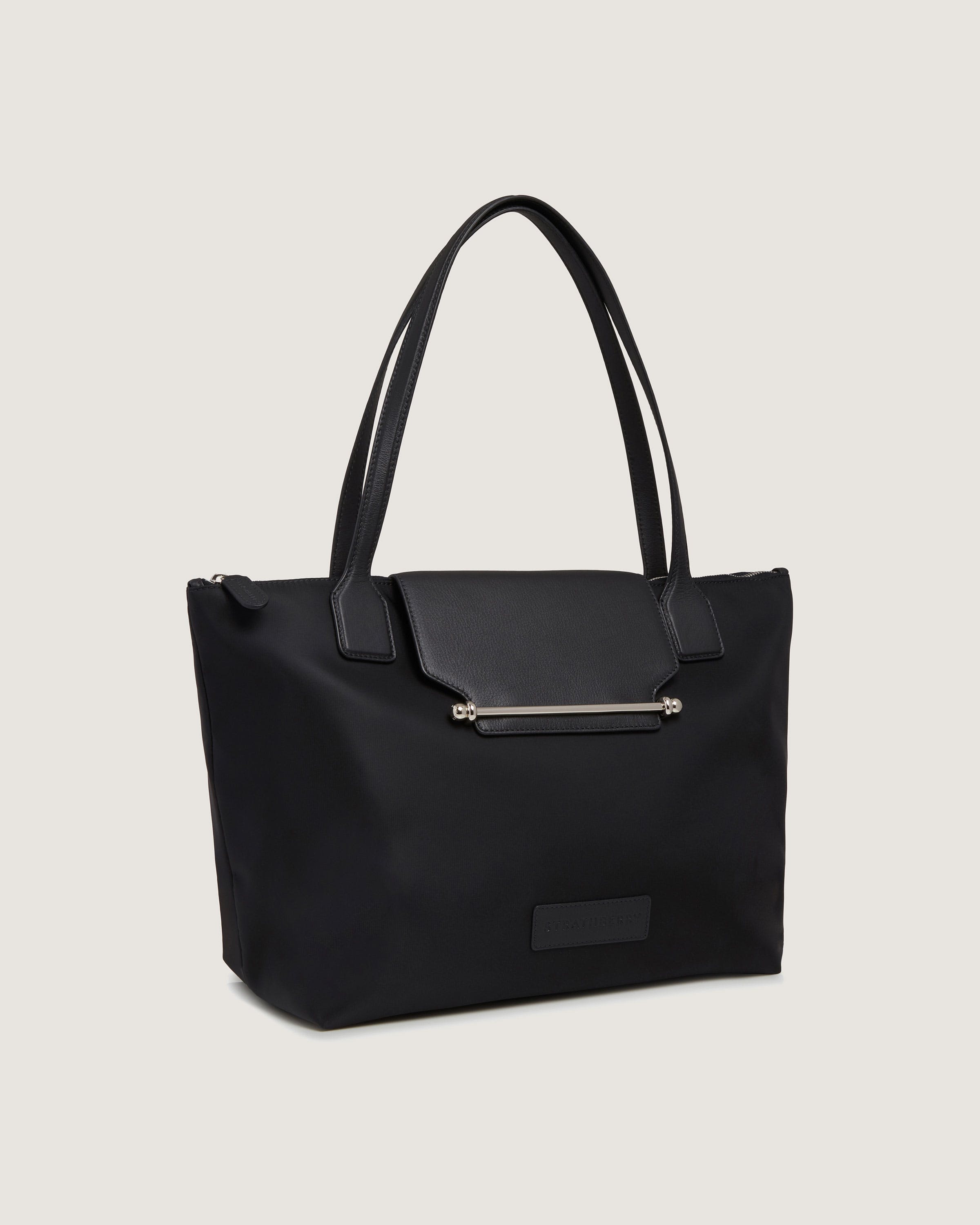 A black tote bag with a zipper