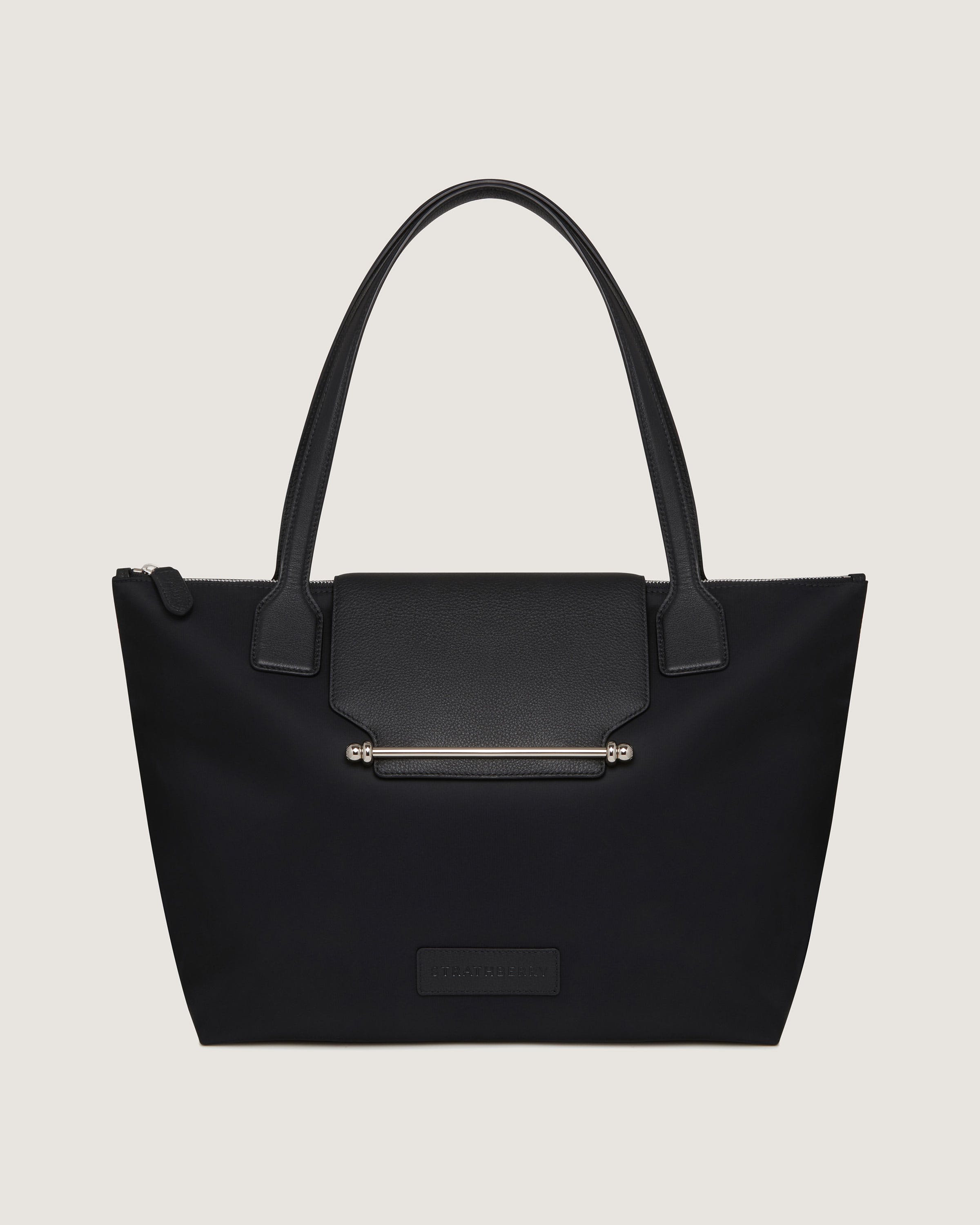 A black tote bag with a zipper