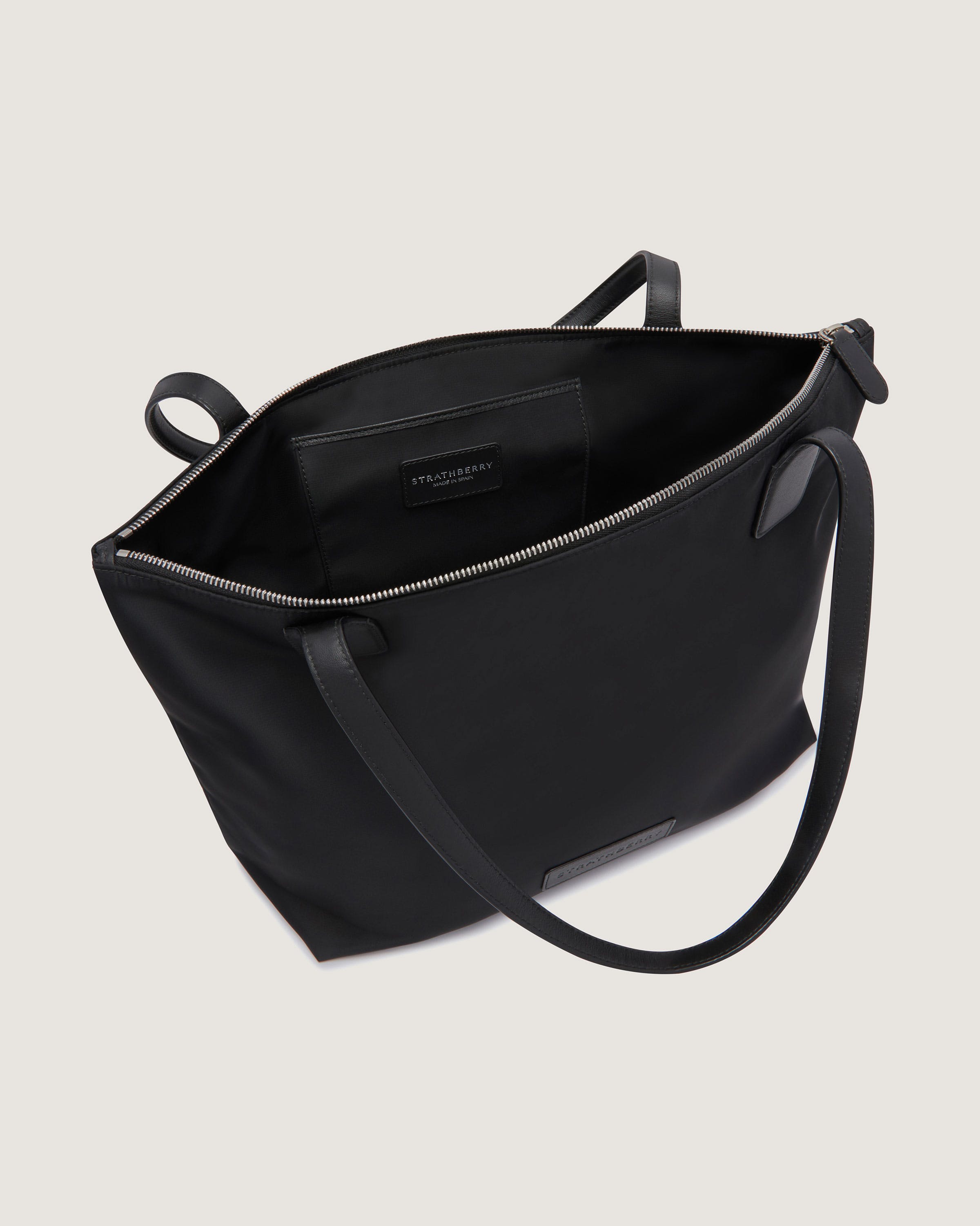 A black tote bag on a white background