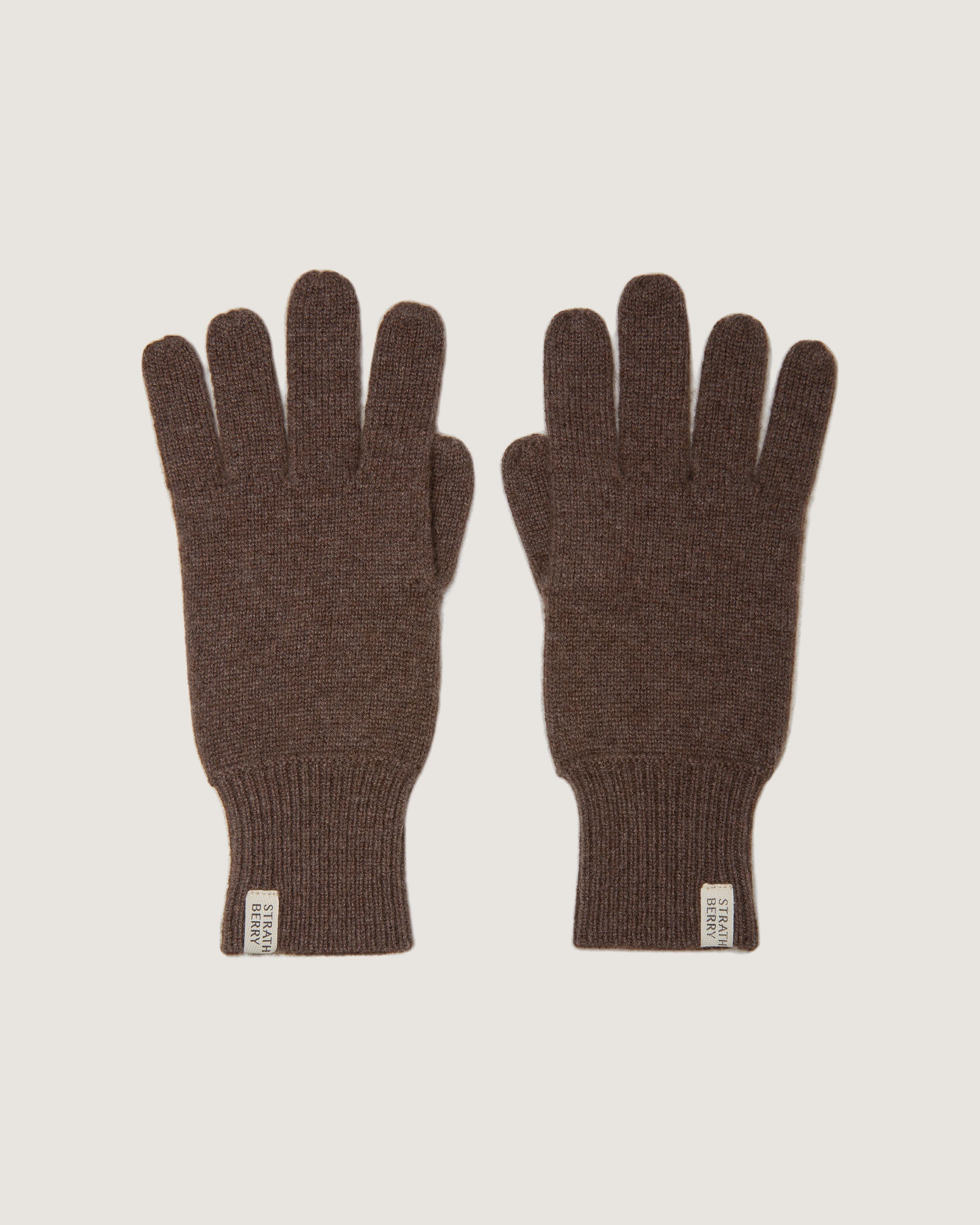 A pair of brown gloves on a white background