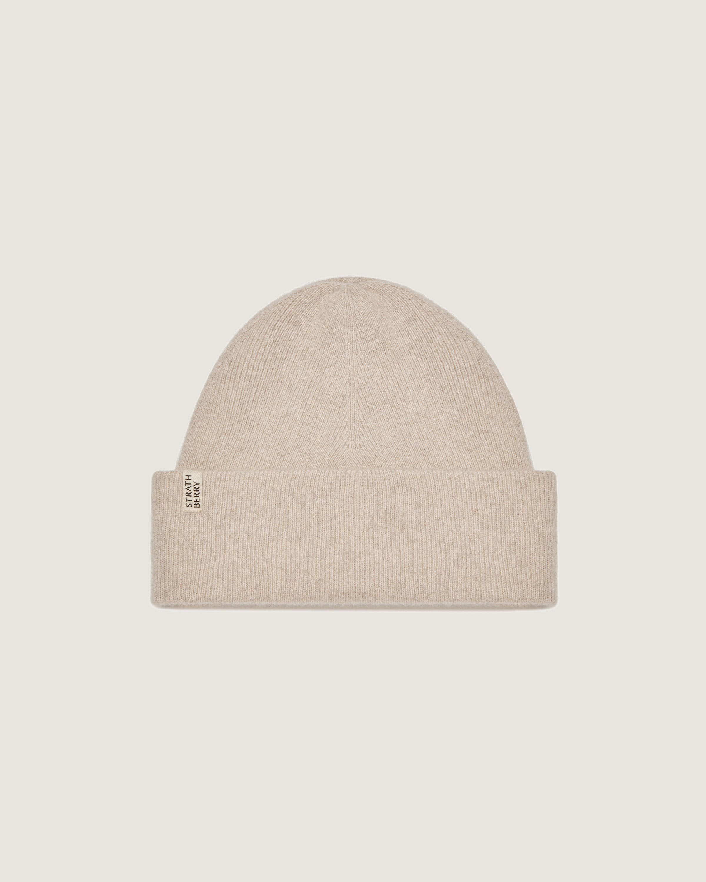 A beige beanie hat on a white background