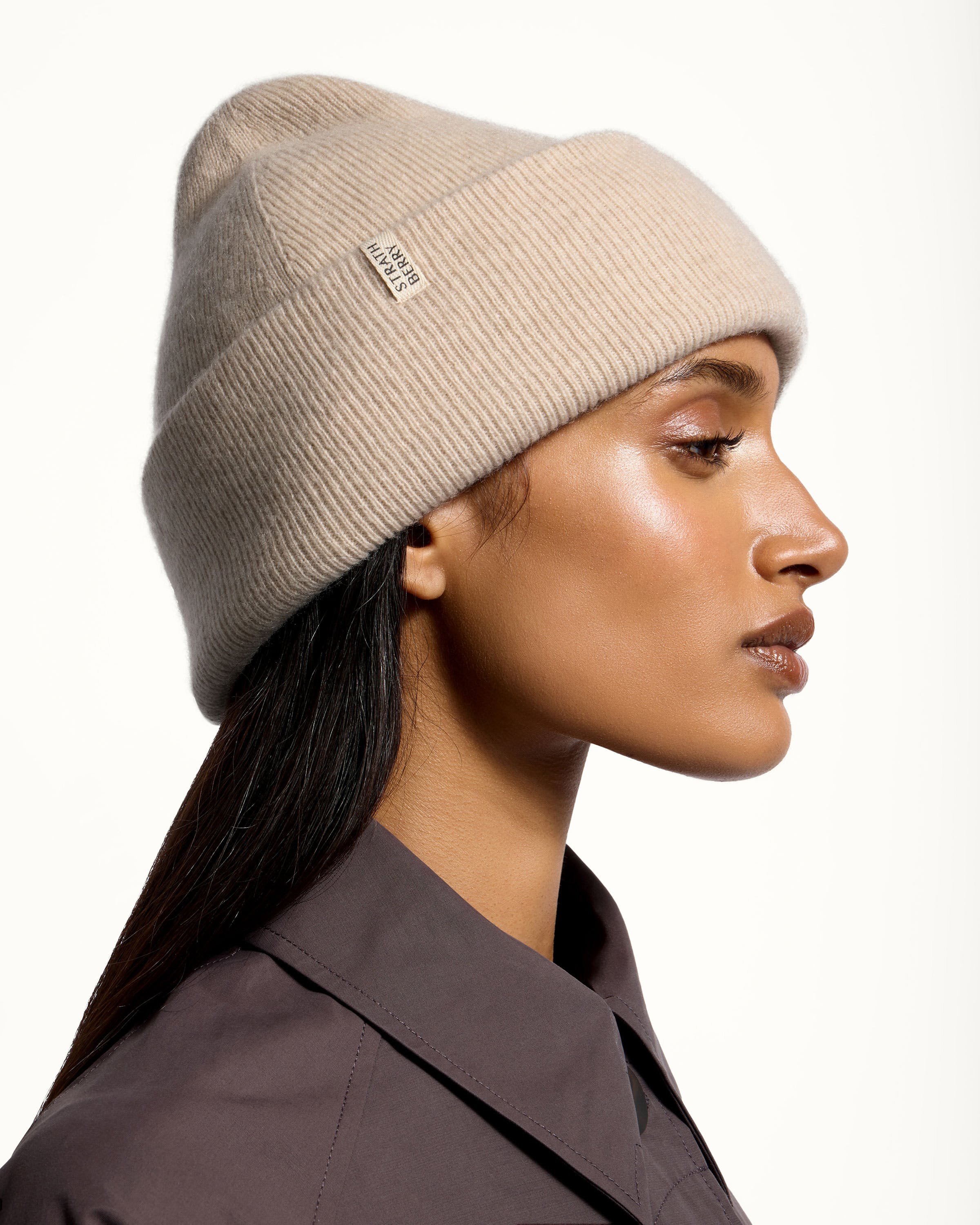 A woman wearing a hat with a ponytail