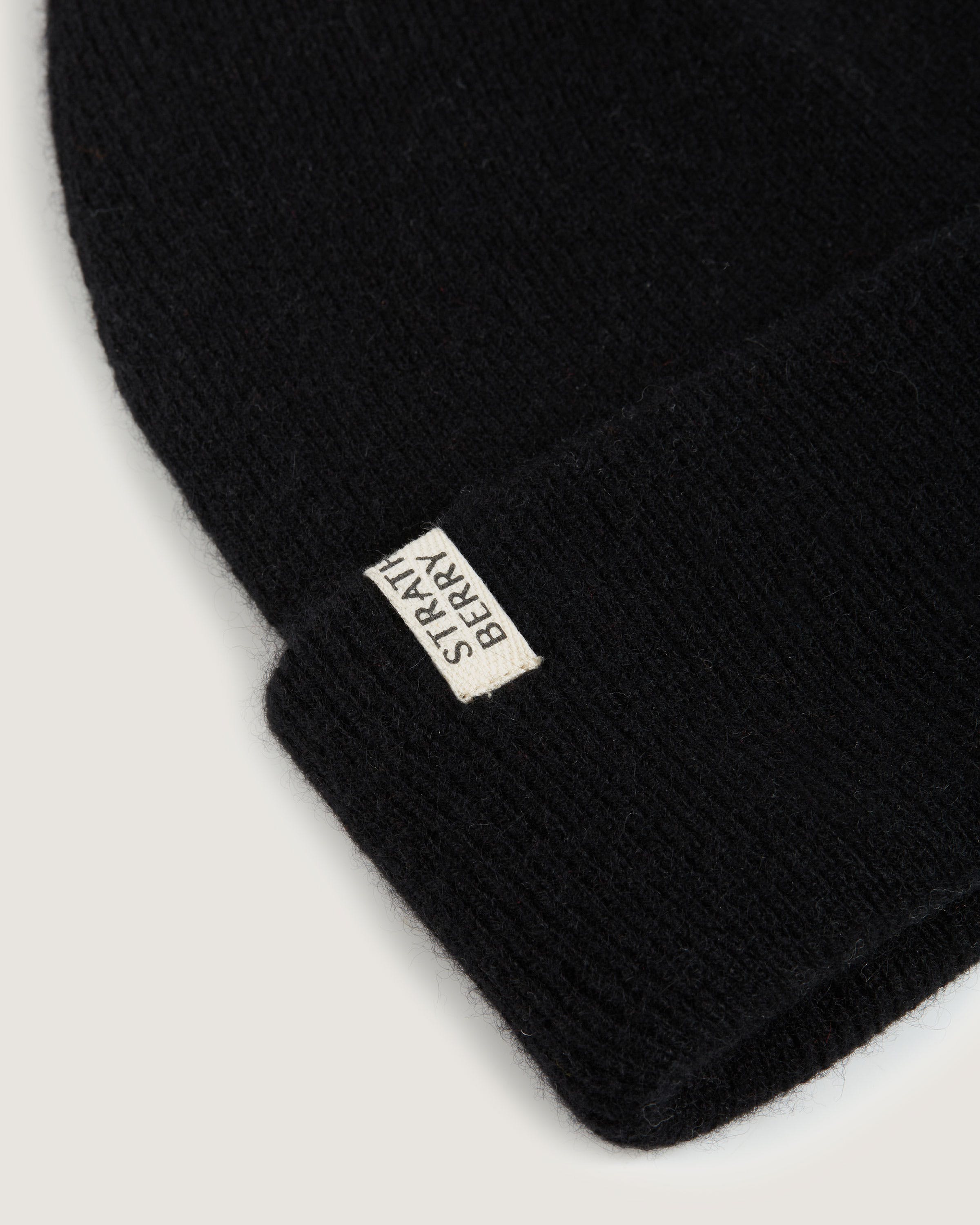 A black beanie with a tag on it