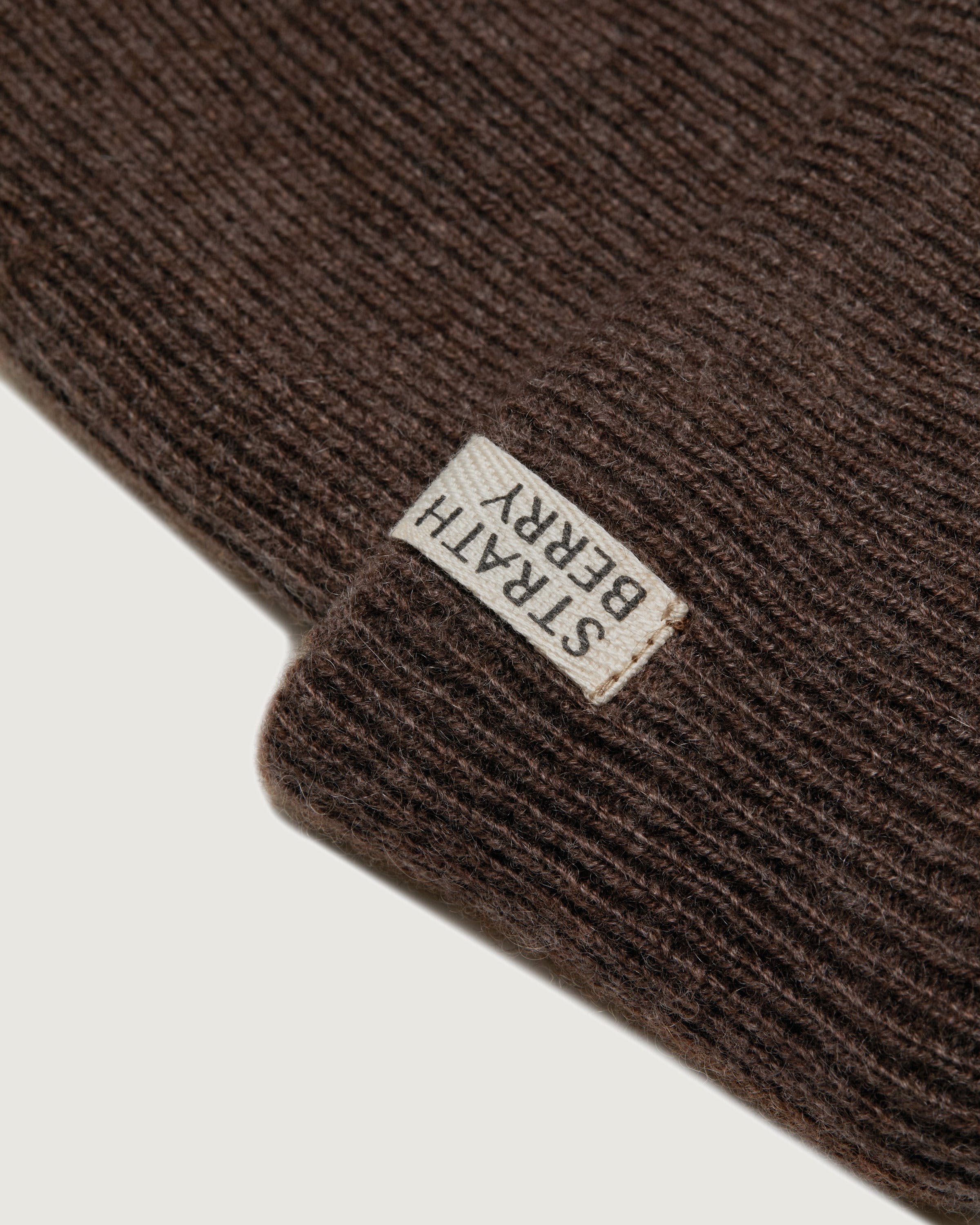 A brown beanie with a label on it