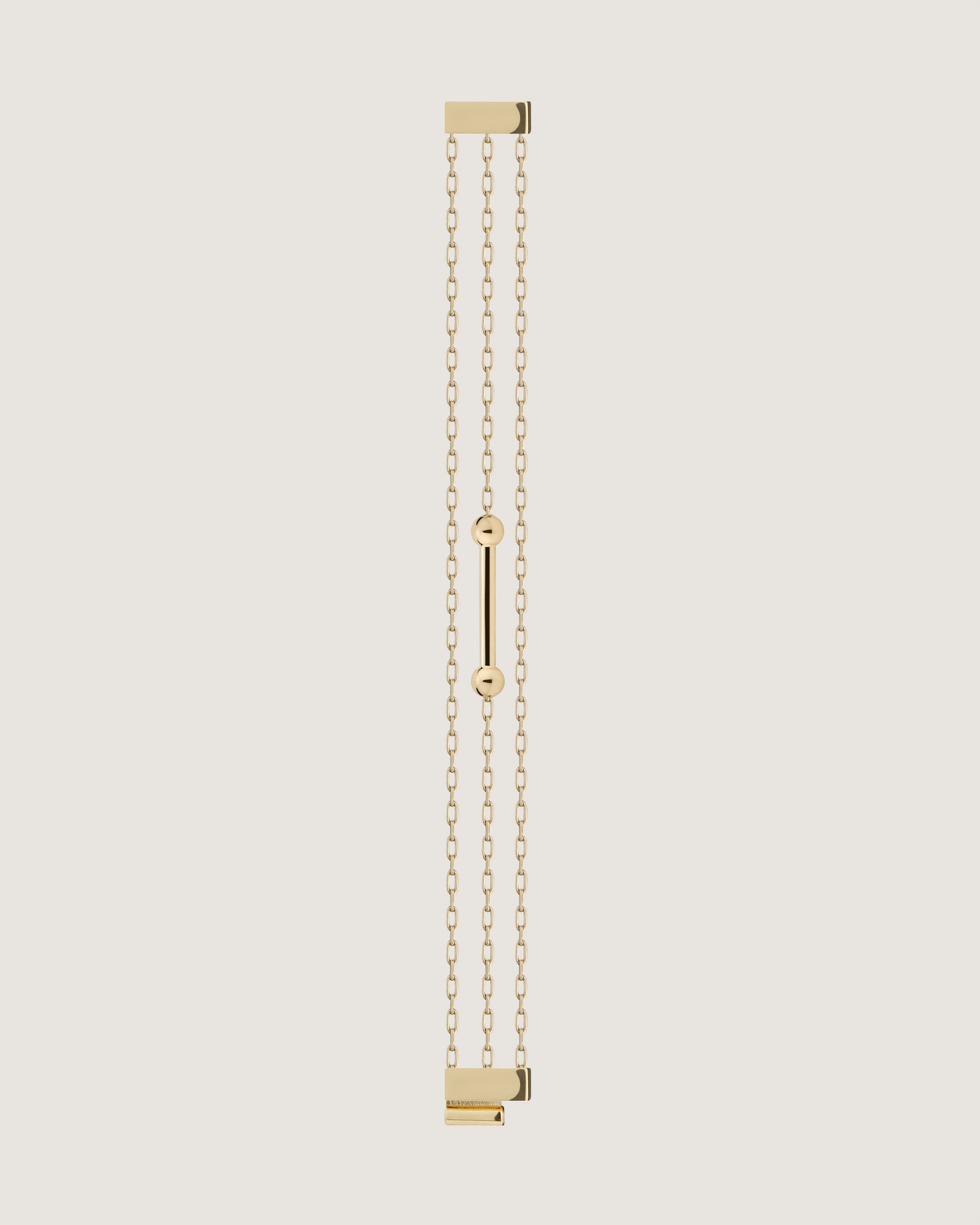 A gold chain with a bar on it