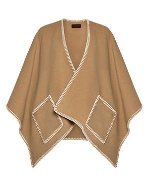 A woman wearing a tan cardigan with a white trim