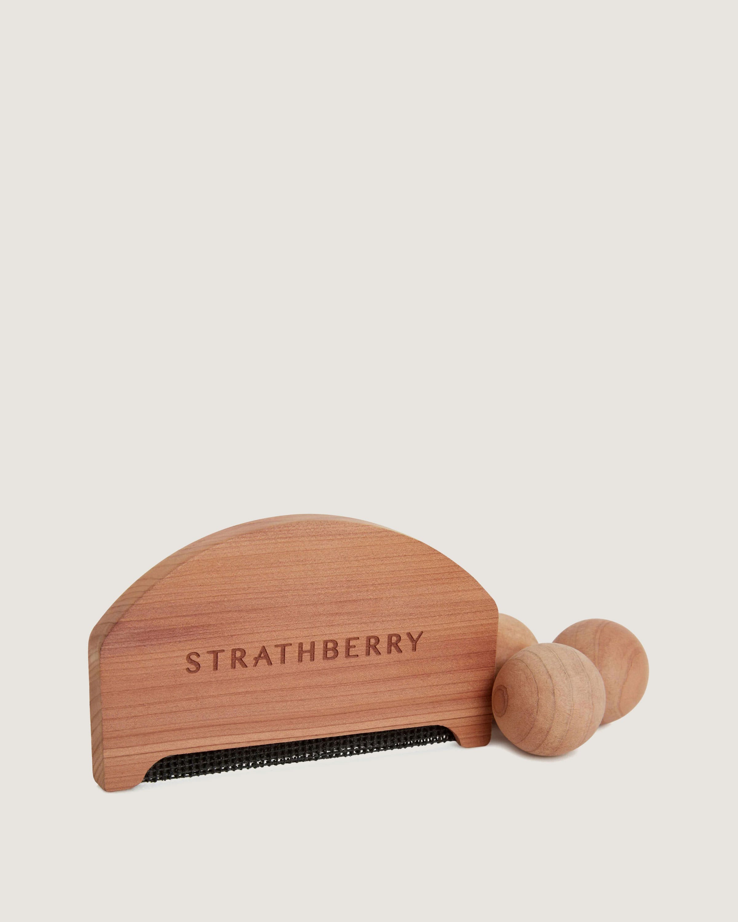 A wooden comb with the words, stratberry on it