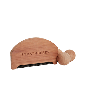 A wooden comb with the word, stratberry on it