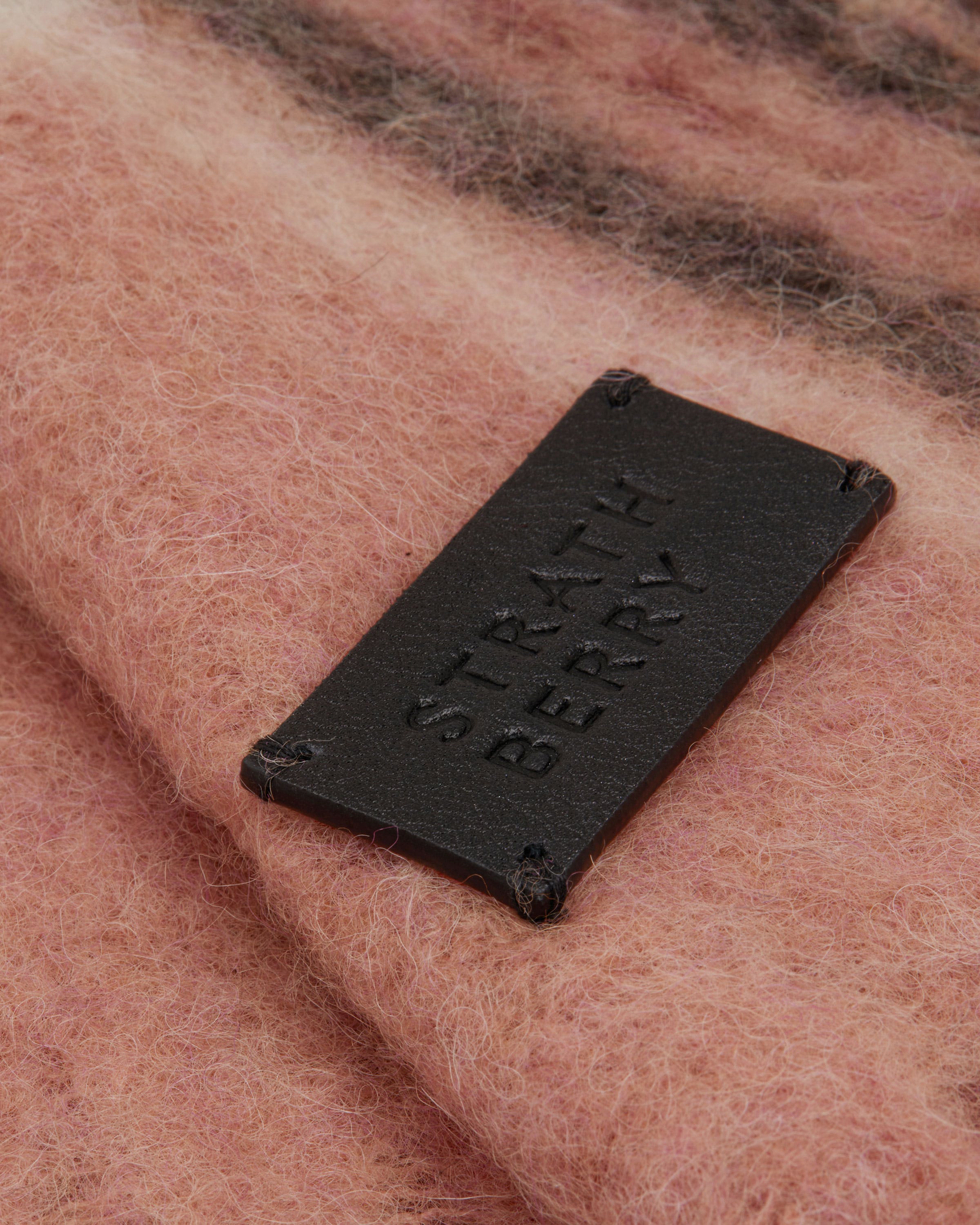 A close up of a wool blanket with a tag on it