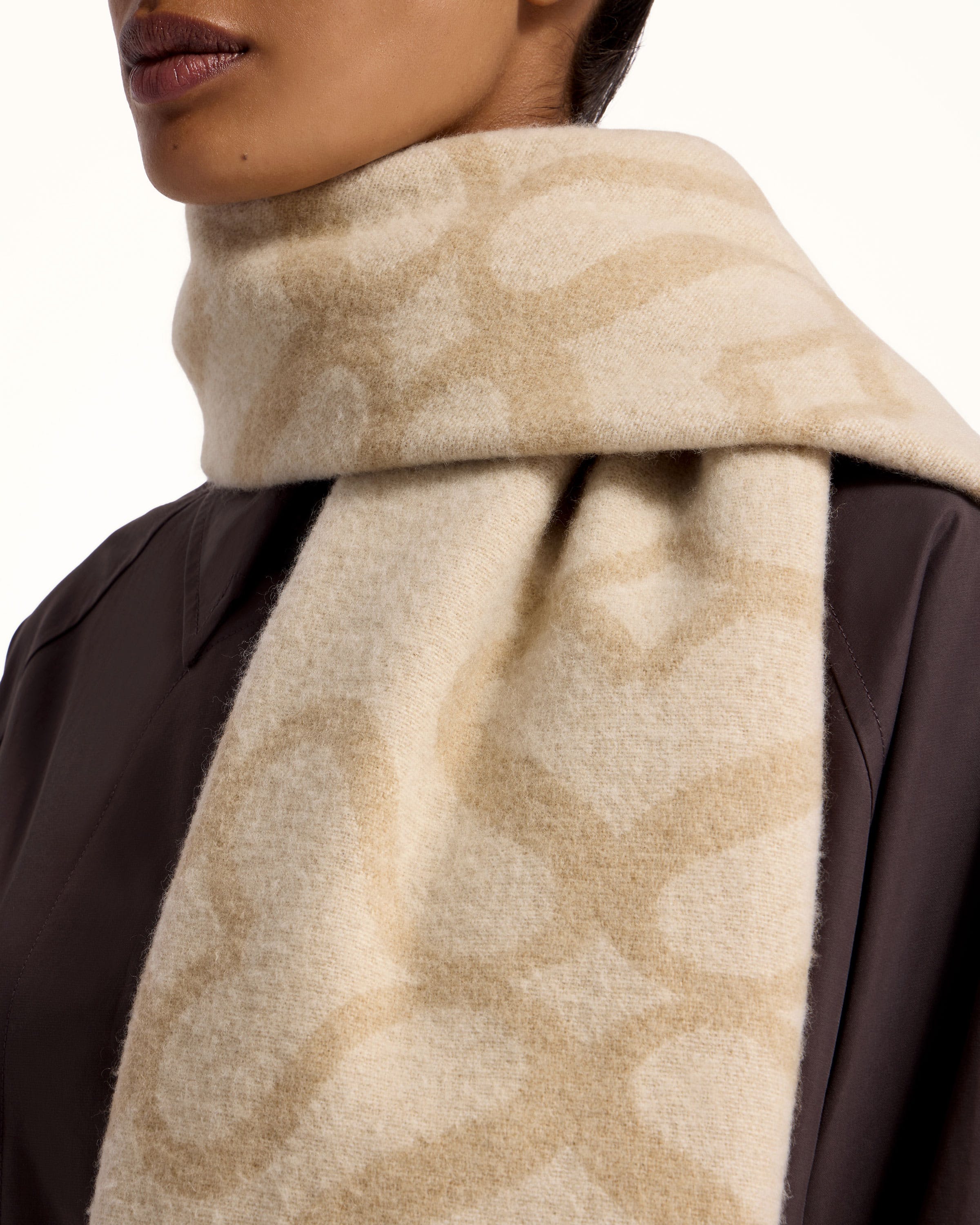 A woman is wearing a scarf with a pattern on it